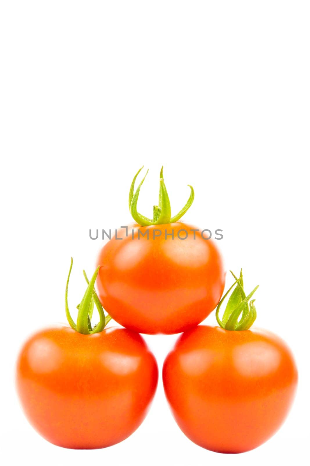 Three tomatoes stacked in pyramid shape