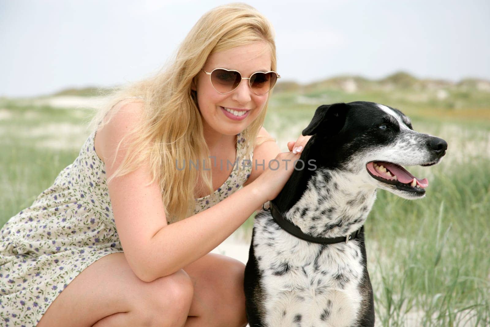 Young woman on the beach with dog
