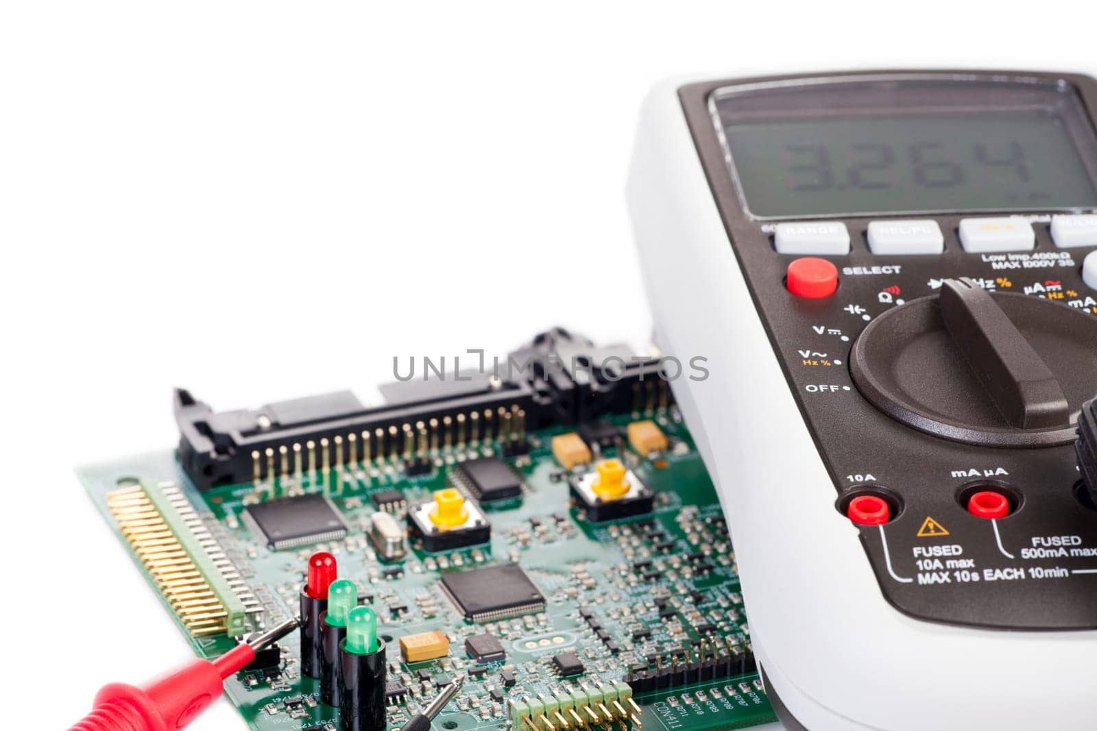 Digital multimeter and board on white background