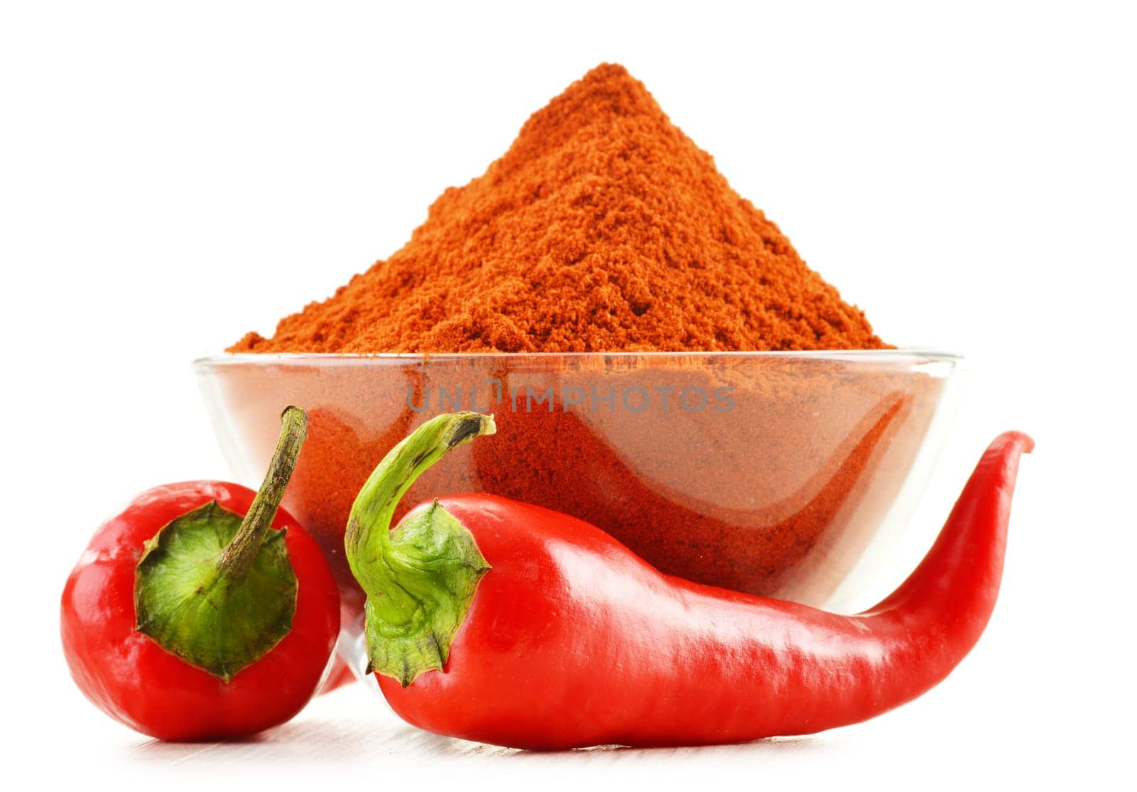 Glass bowl with red hot chili pepper isolated on white