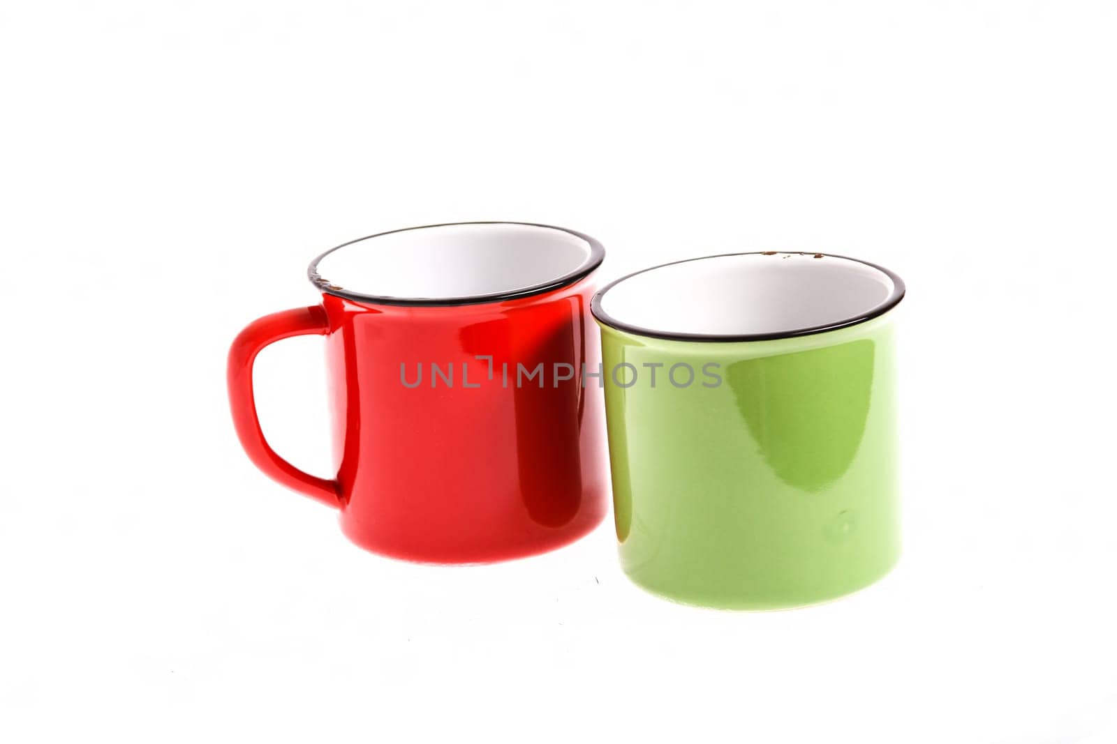 A red and a green cups, both empty, isolated.