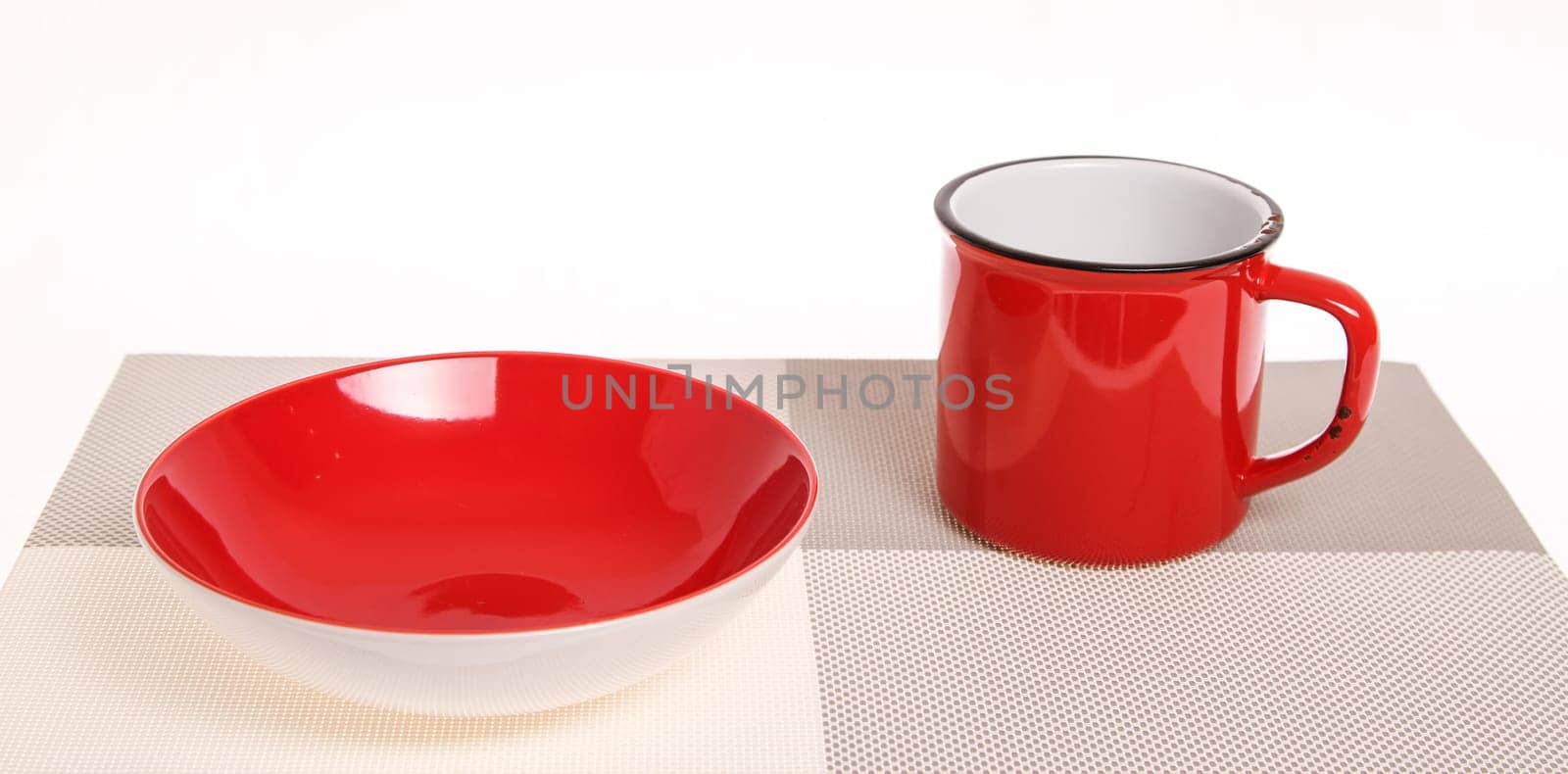 A red broken-down cup and bowl, empty..