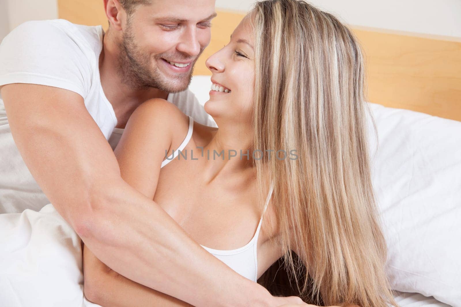 Young happy couple in bed