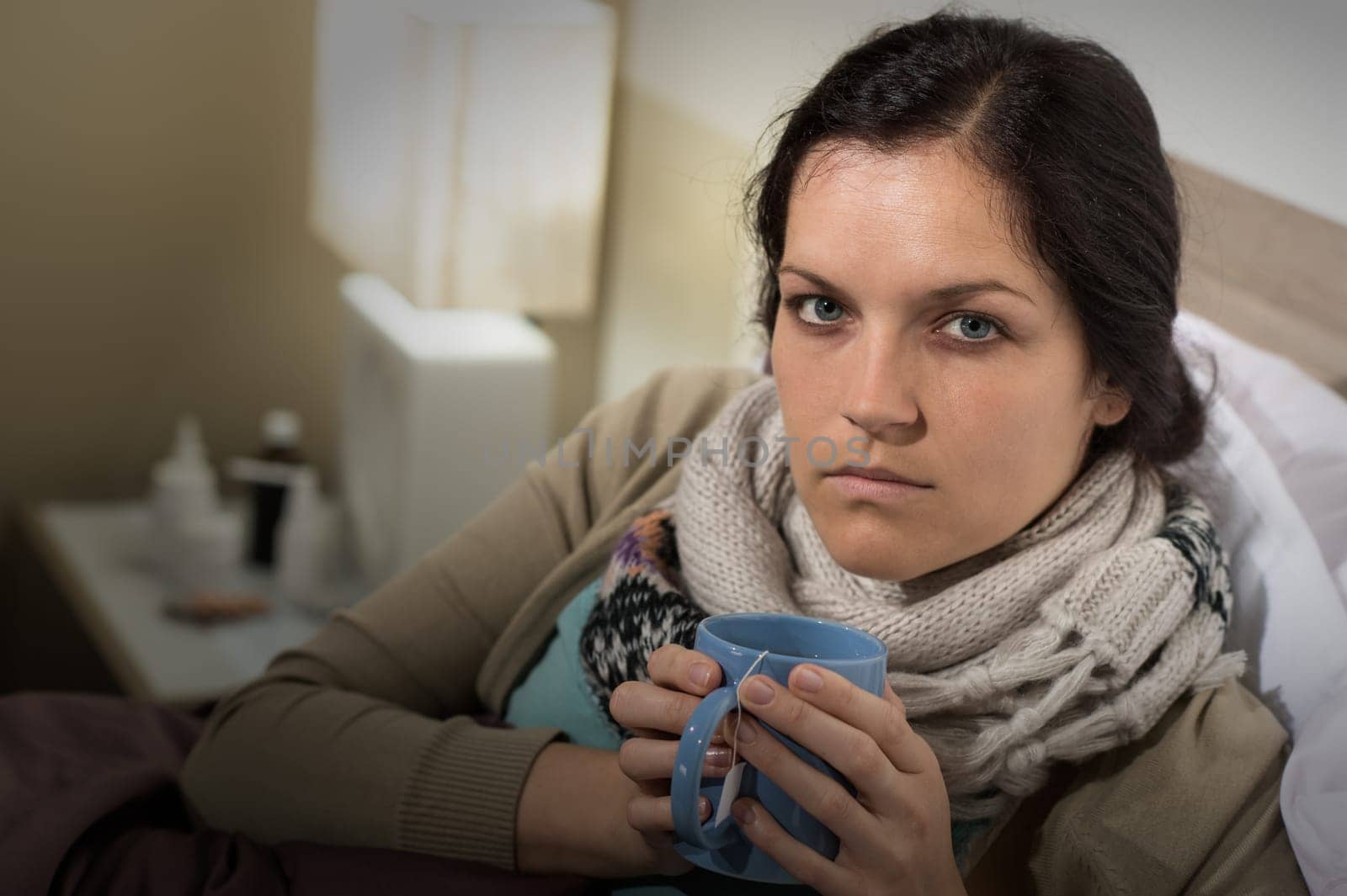Portrait of woman having flu sore throat drinking tea