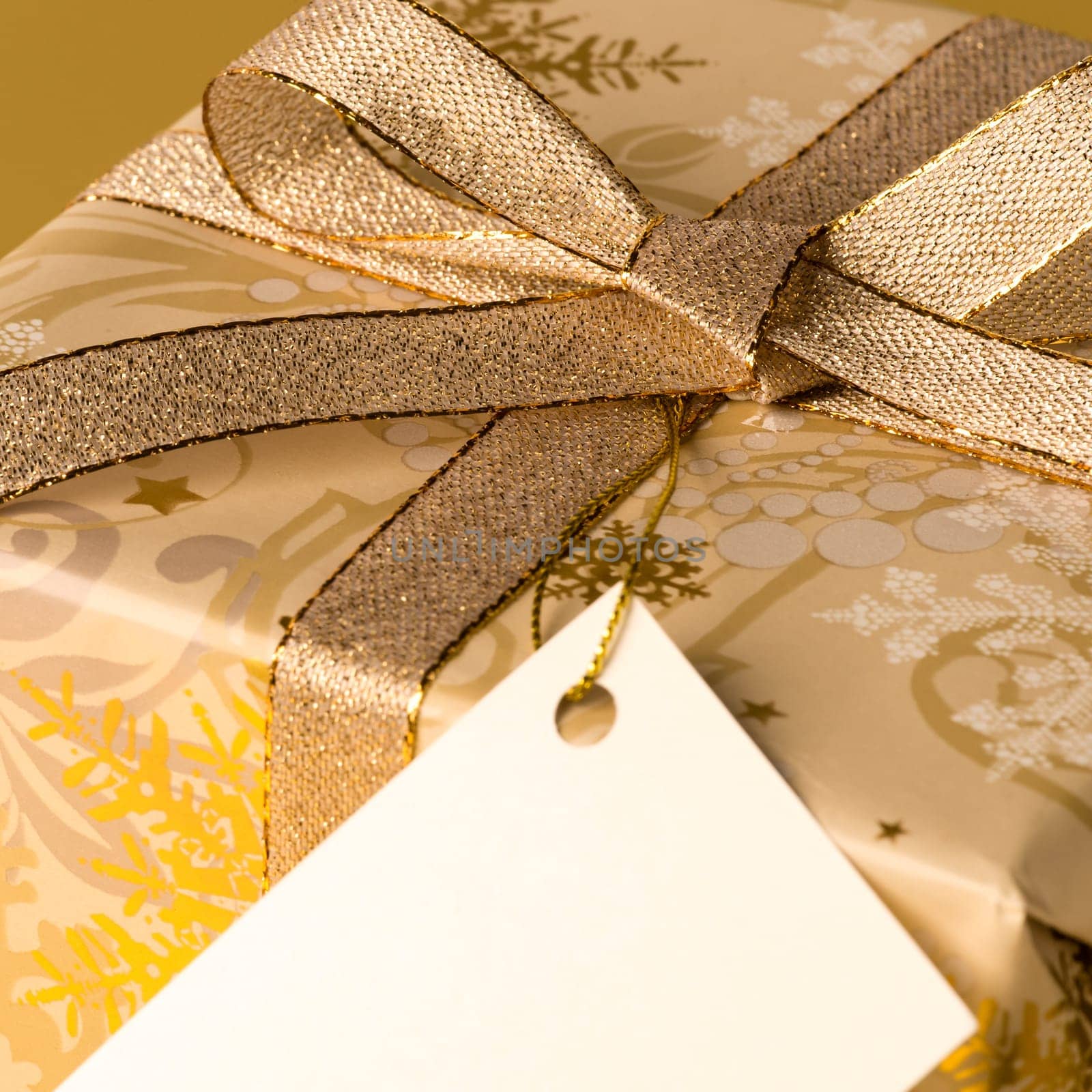 Gold Christmas gift with blank label wishing card