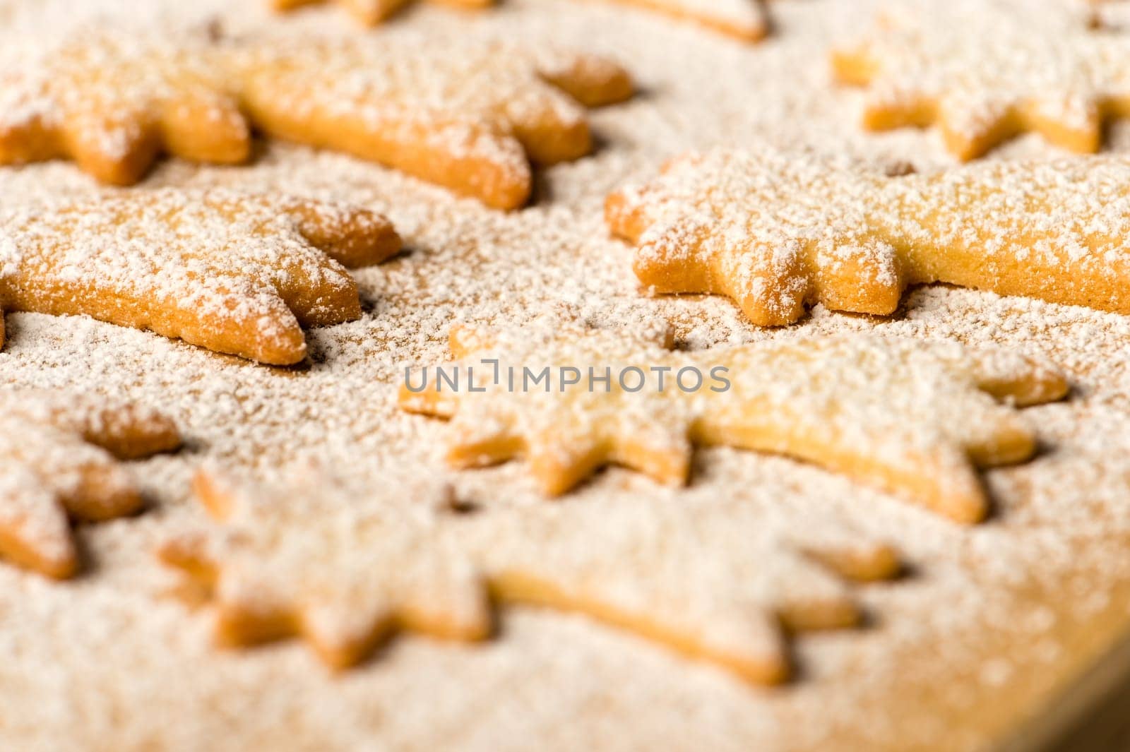Baking christmas cookies comet star with powdered sugar