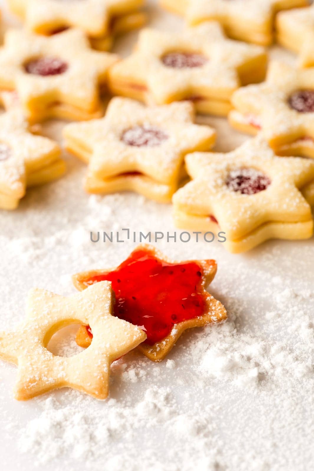 Gingerbread christmas cookie star with jam and powdered sugar
