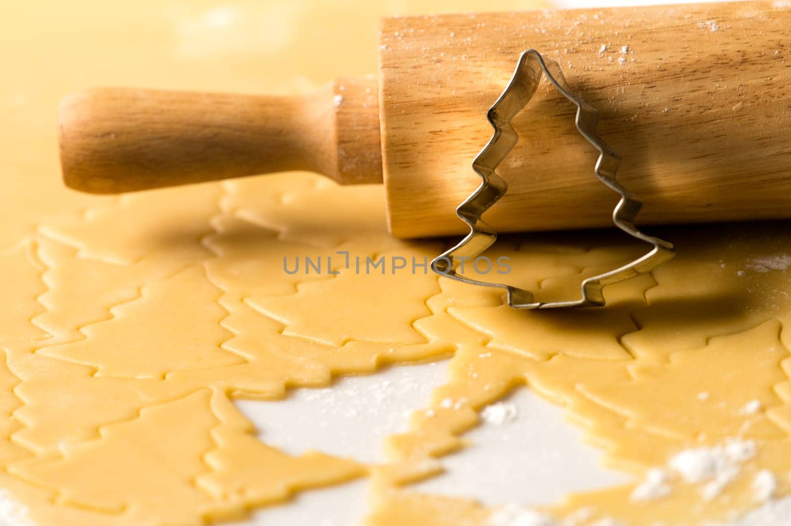 Baking christmas cookies raw dough with rolling pin and cutter
