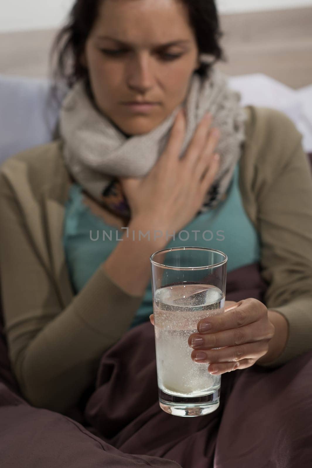 Sick woman preparing cold flu medicine to drink
