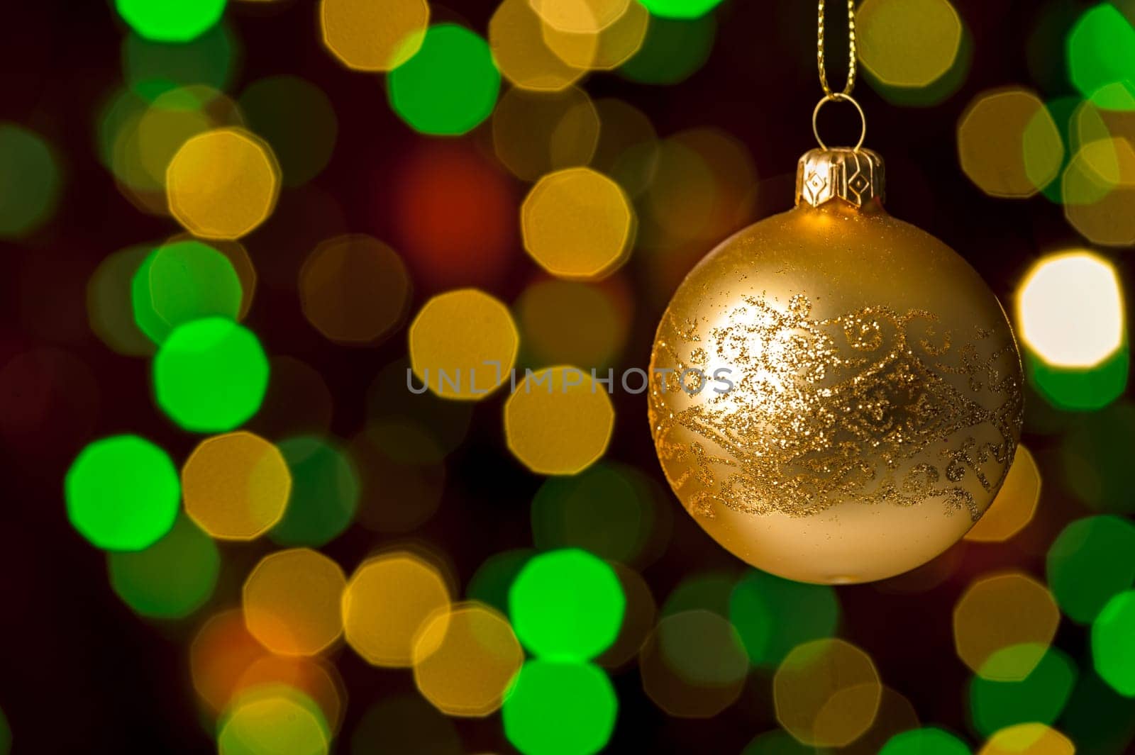 Christmas ball hanging defocused sparkling lights on the background