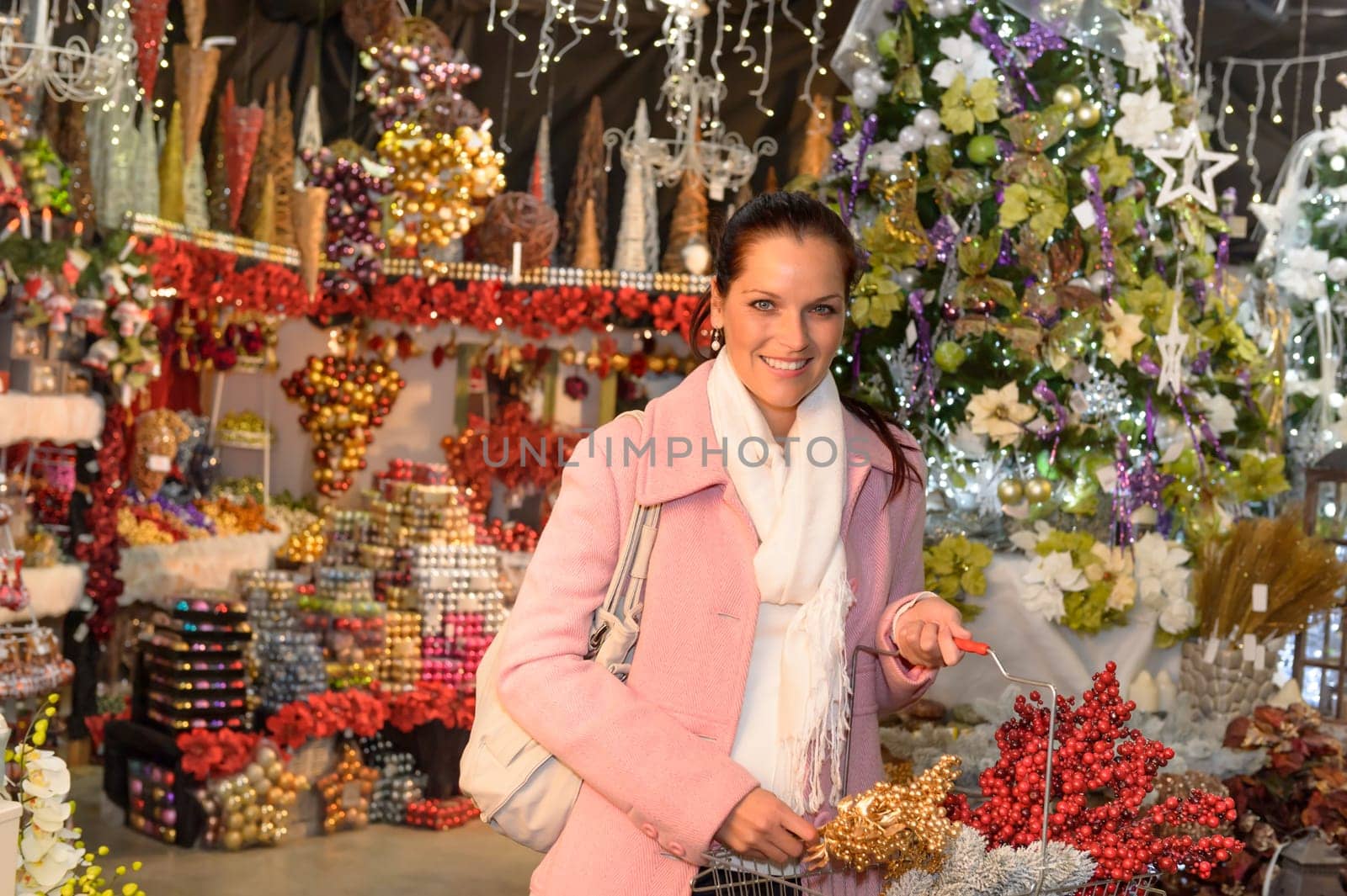 Happy woman purchasing Christmas ornaments at wintertime