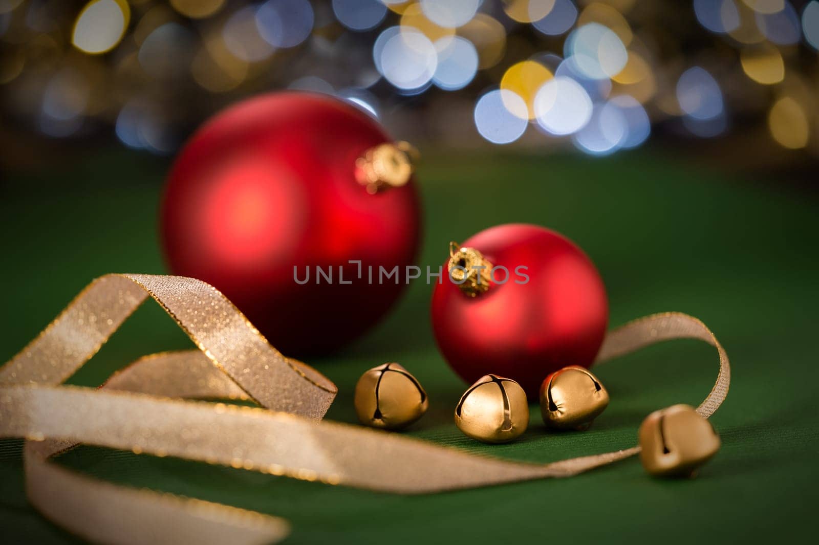 Red christmas baubles and gold jingle bell with shinning lights