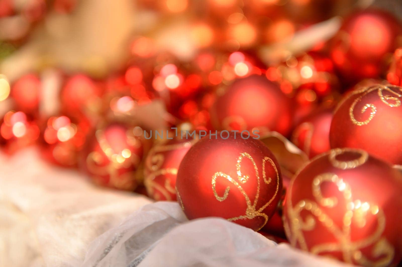 Pile of red Christmas balls with gold ornament