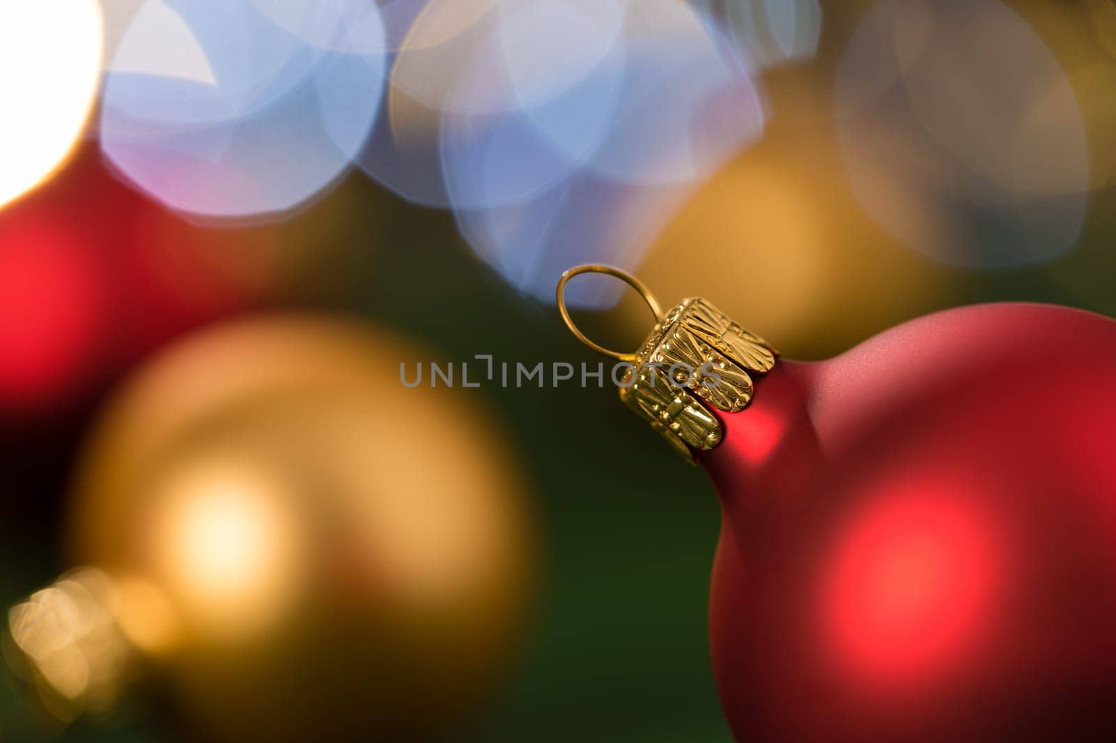 Christmas red and gold balls close-up shining lights background