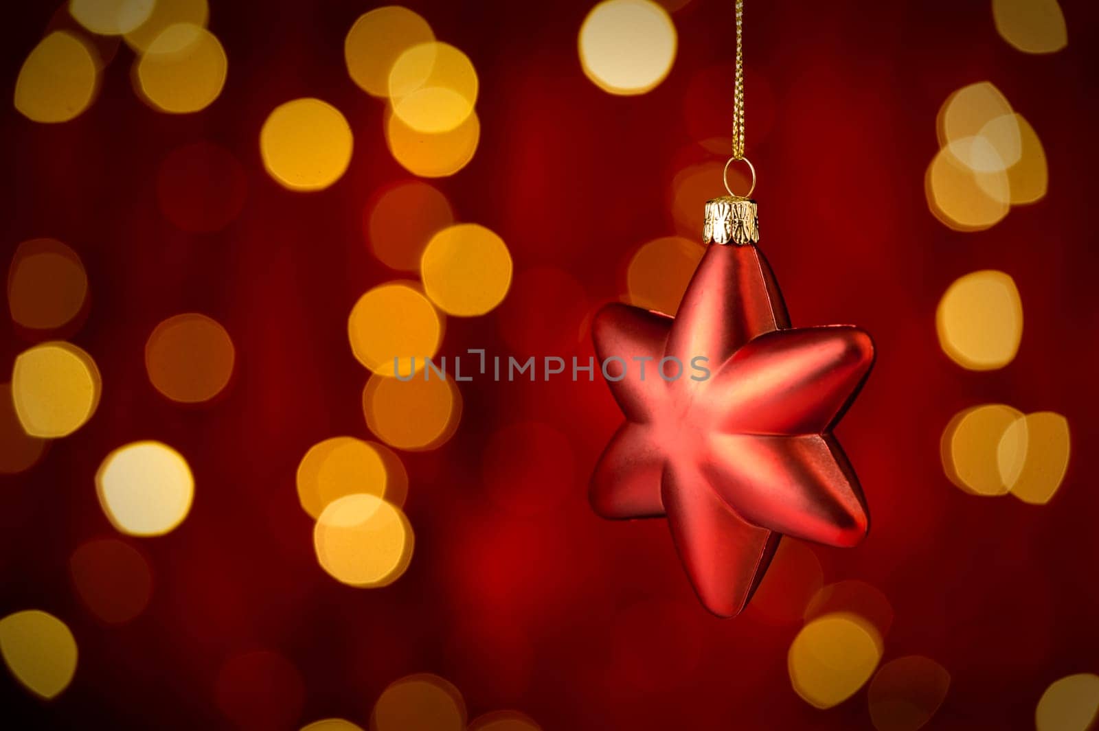 Hanging Christmas Ornament star with sparkling lights in background