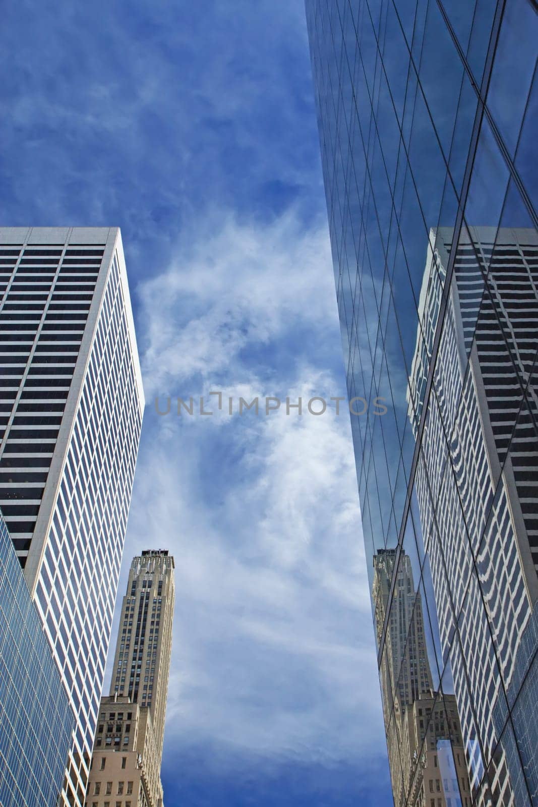 Skyscrapers in New York City. Blue sky in the background. Vertically.