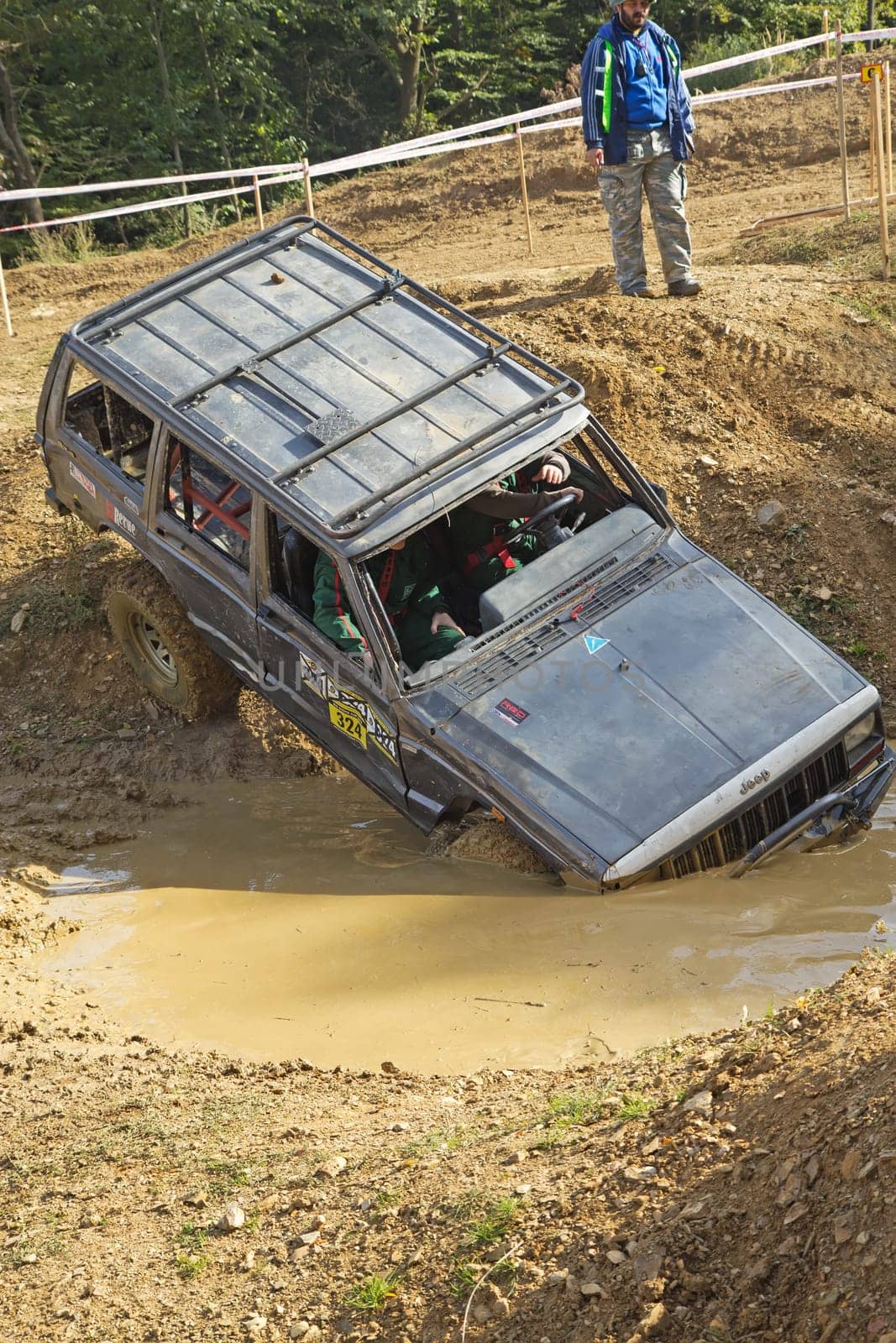 MOHELNICE, CZECH REPUBLIC - OCT 05. Off-road car is entering into a puddle of mud in the "BIG SHOCK CUP Trial 2013"" on October 05, 2013 in Mohelnice, Czech Republic."
