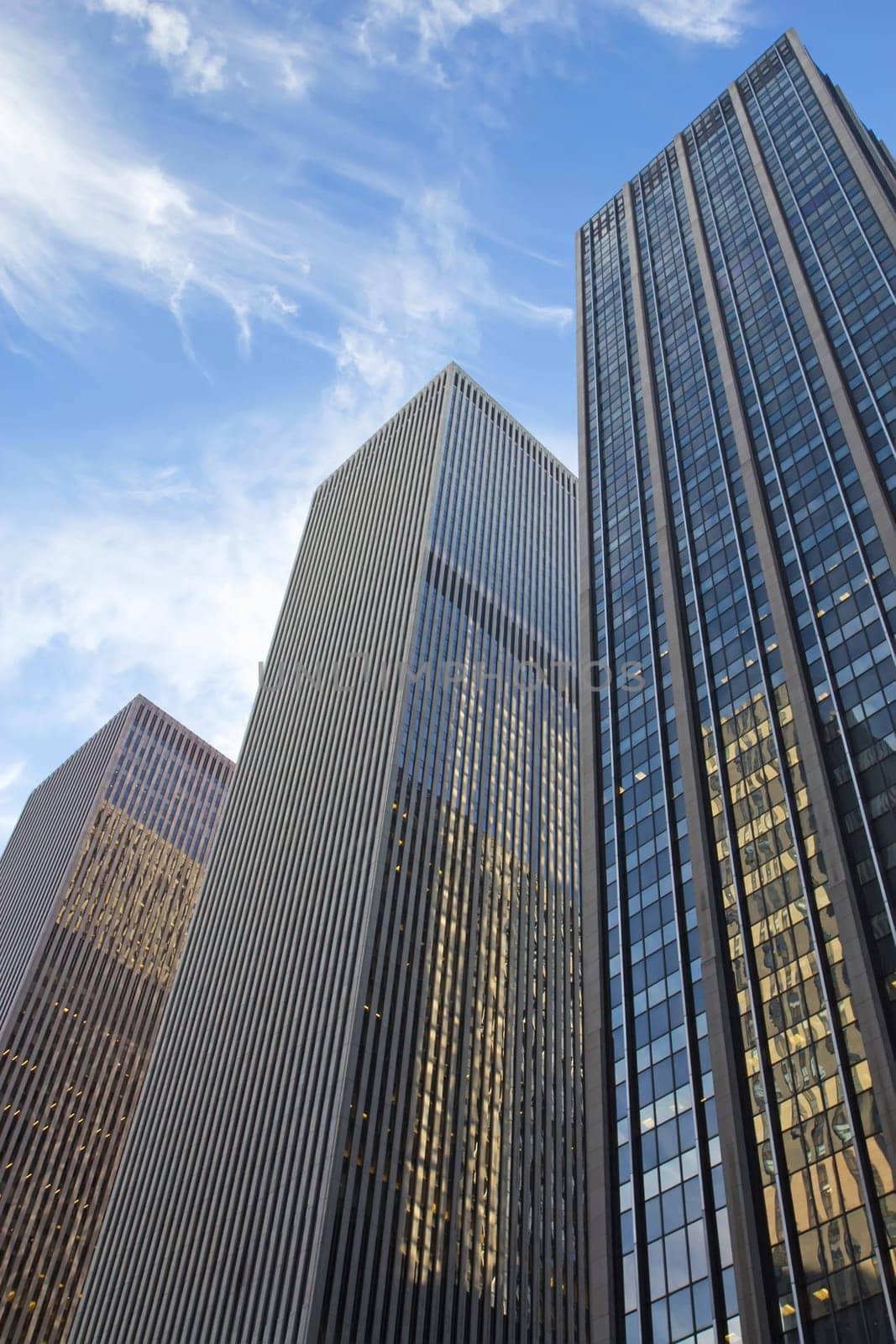 Skyscrapers in New York City. Blue sky in the background. Vertically.