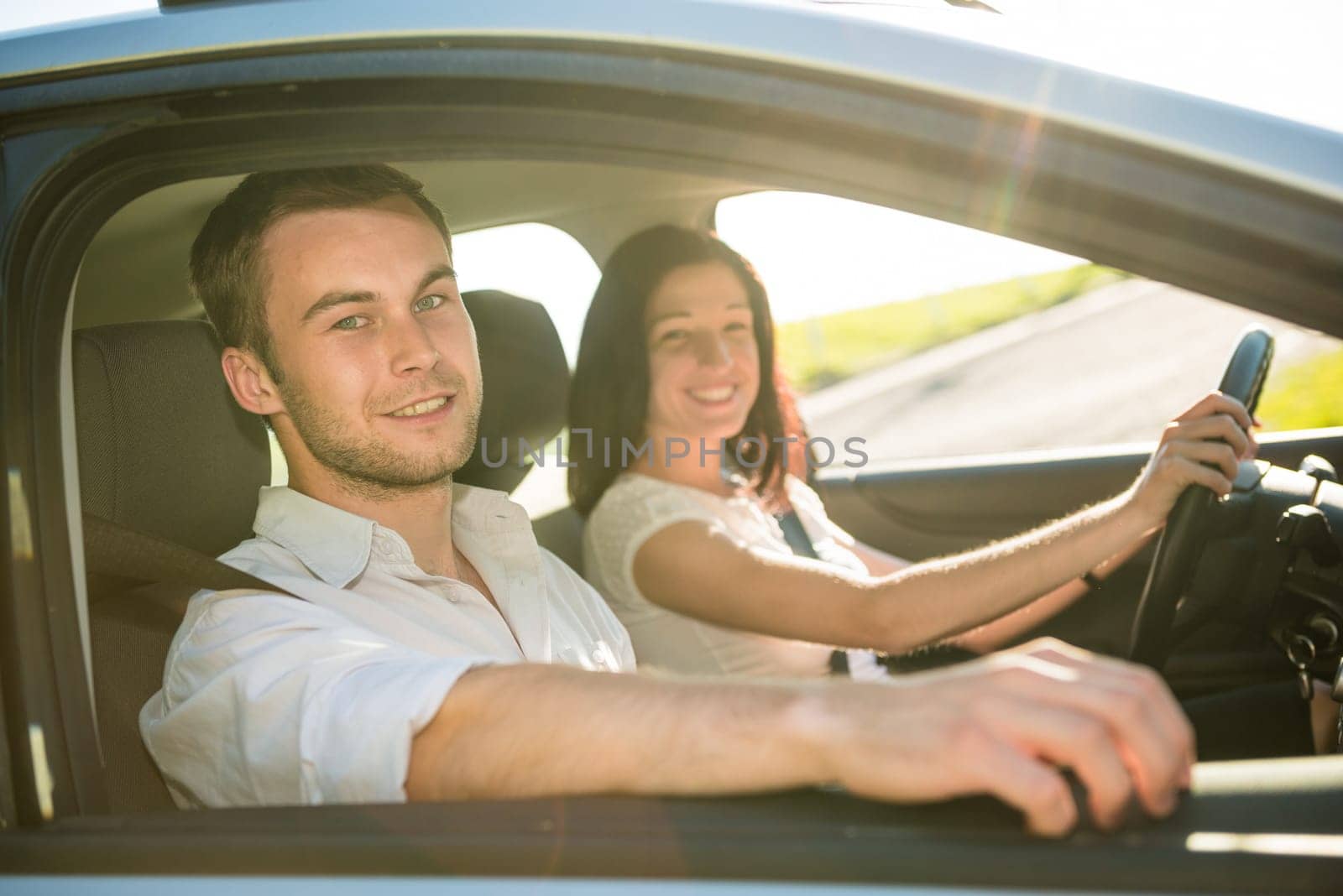 Happy time together - couple in car, woman is driving