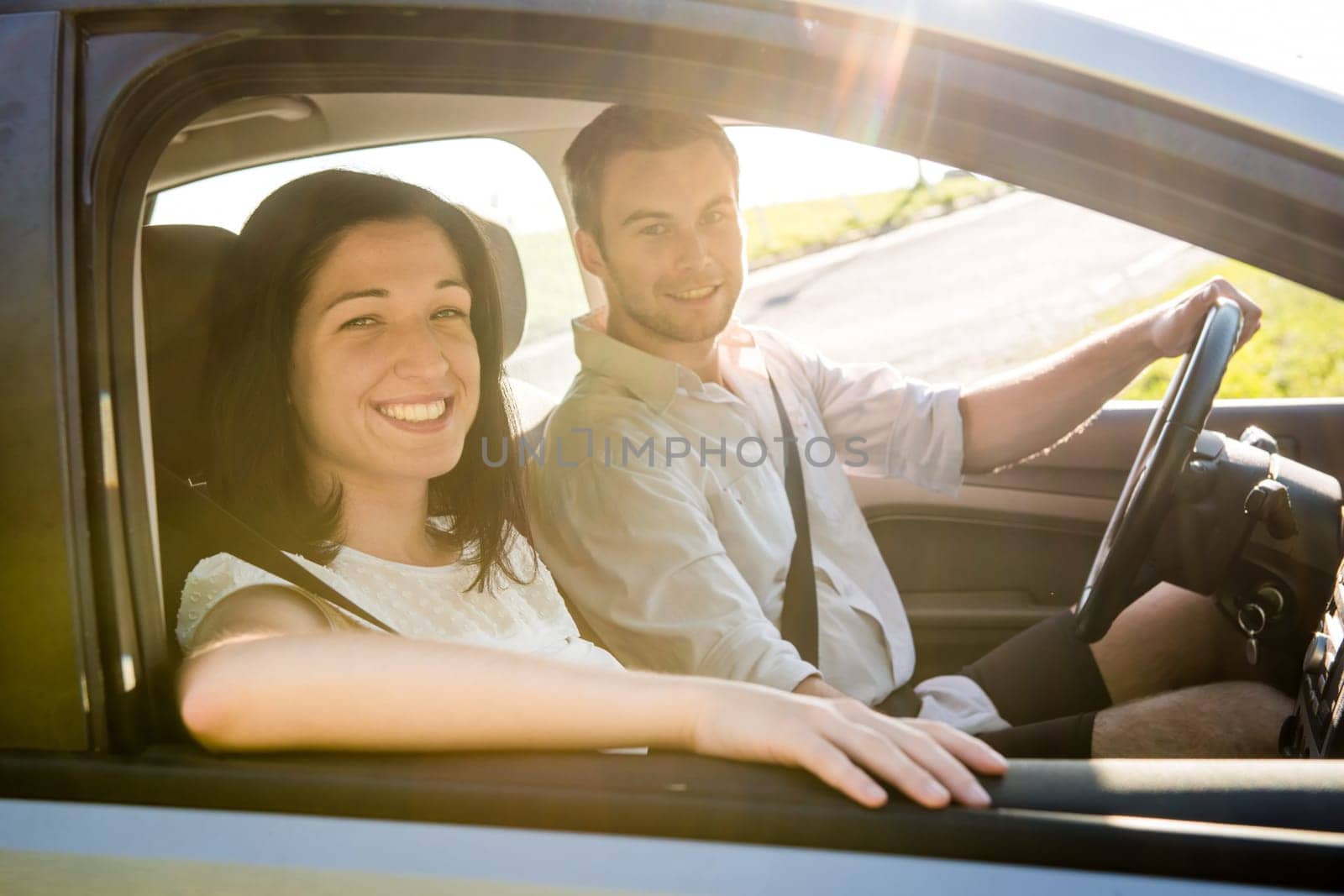 Happy time together - couple in car, man is driving