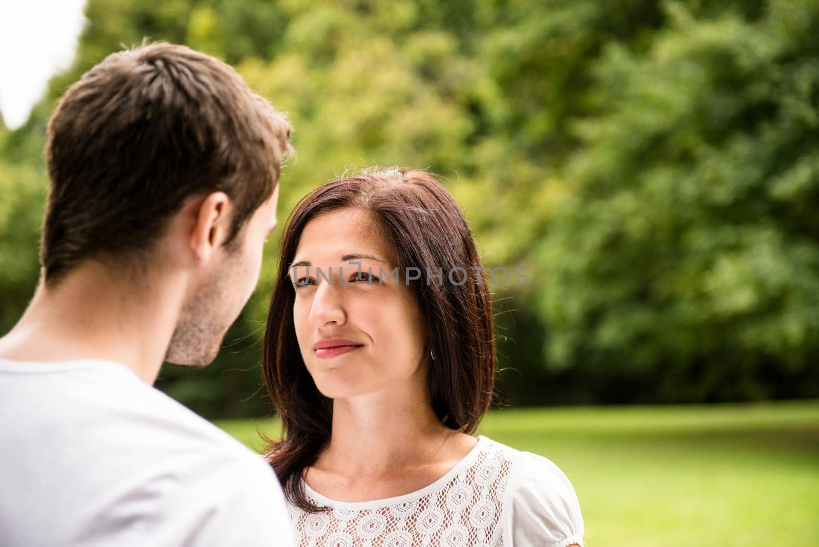 Young happy couple looking on each other - outdoor lifestyle portrait