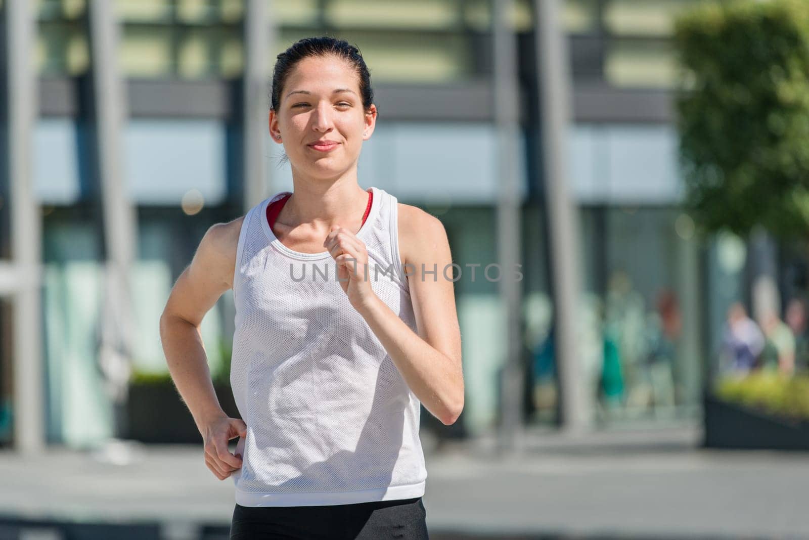 Running lifestyle - young sport woman jogging in street