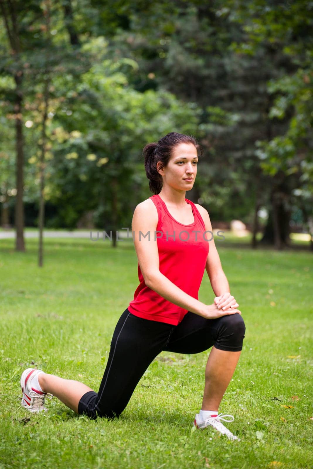 Young sport woman exercising before jogging - outside in nature