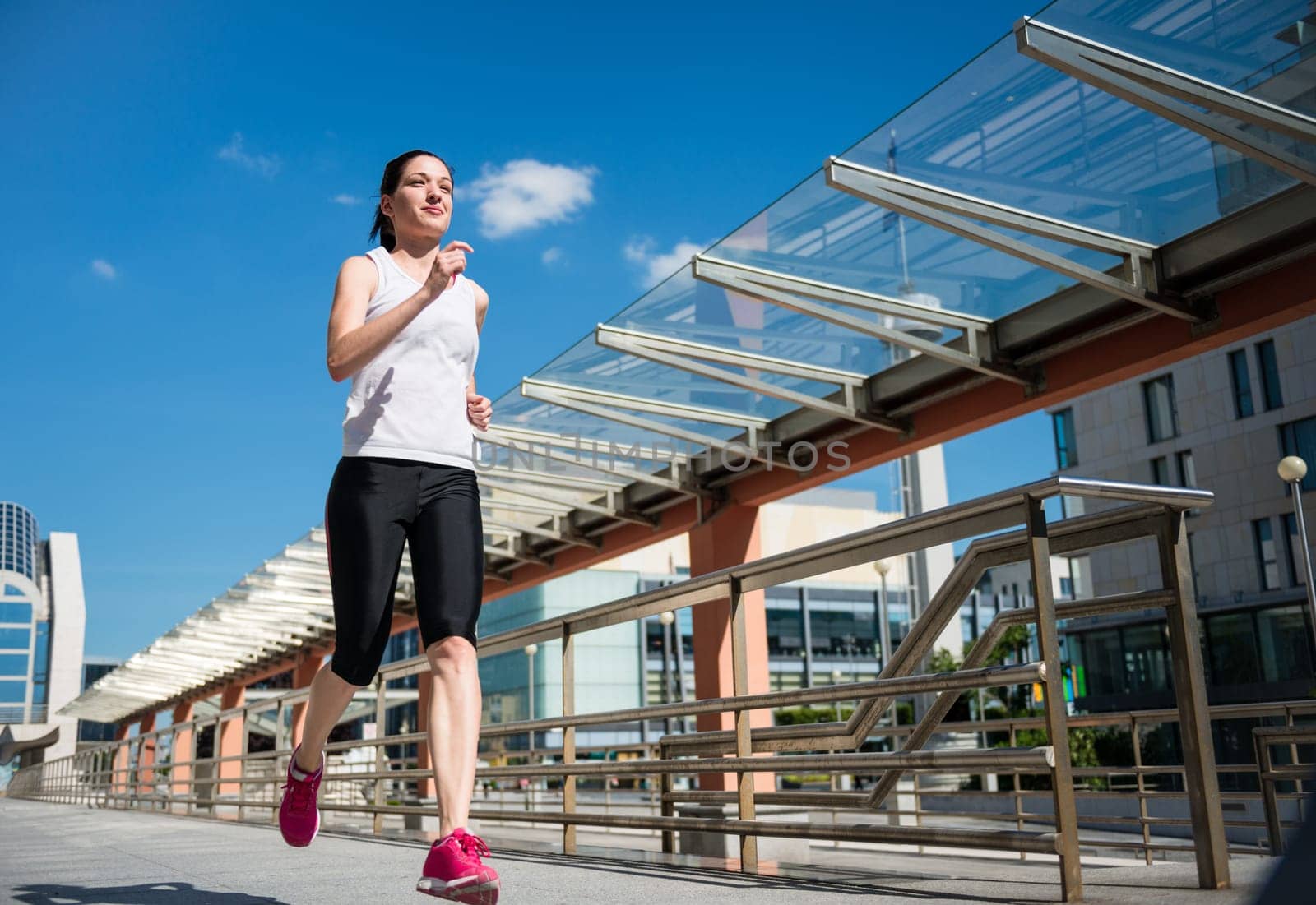 Running lifestyle - young sport woman jogging in street