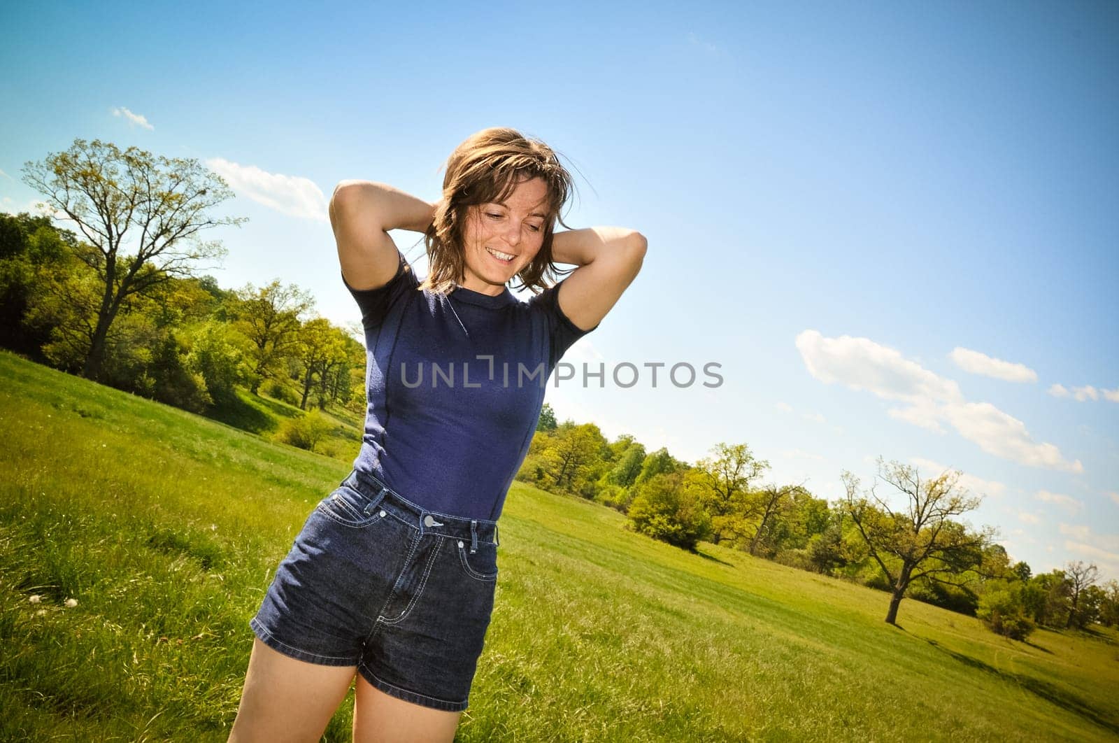 Woman enyoing life outdoors in green sunny park (pleasure expression)