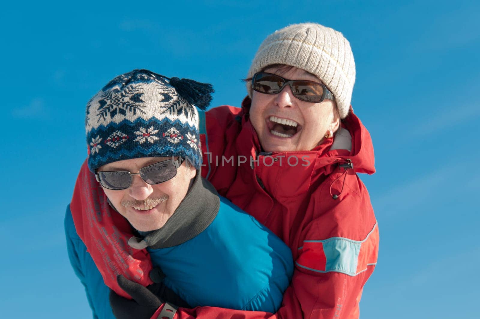 Active senior couple - smiling mature man and woman outdoor in winter