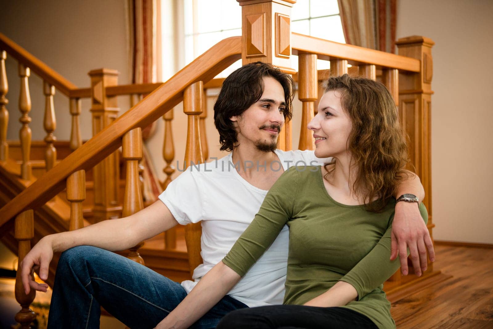 Portrait of young happy smiling couple - indoor settinguple portrait