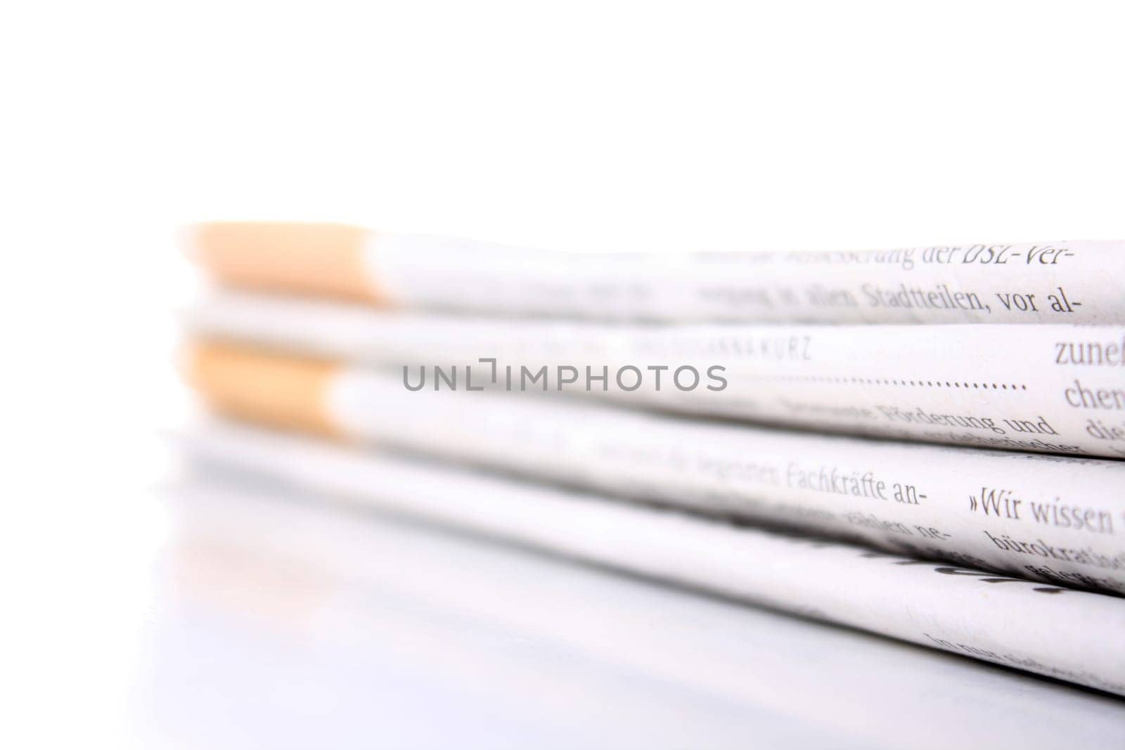 several newspapers stacked with white background