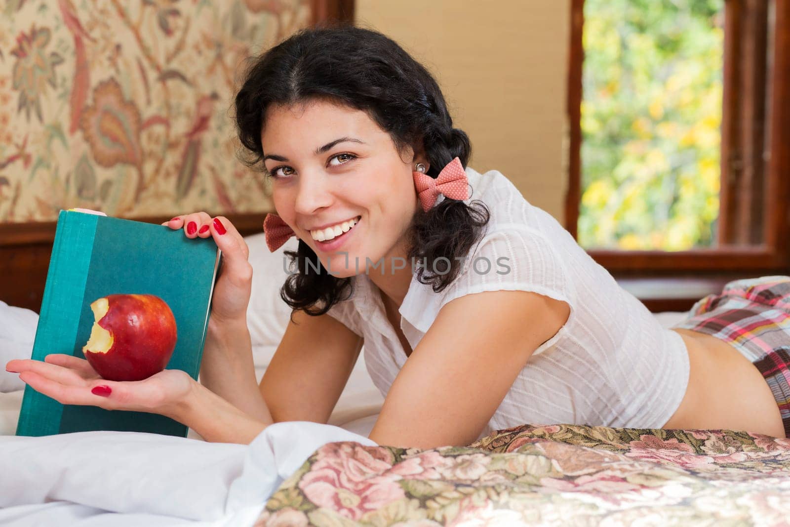 Woman show half bitten apple and brightly smile