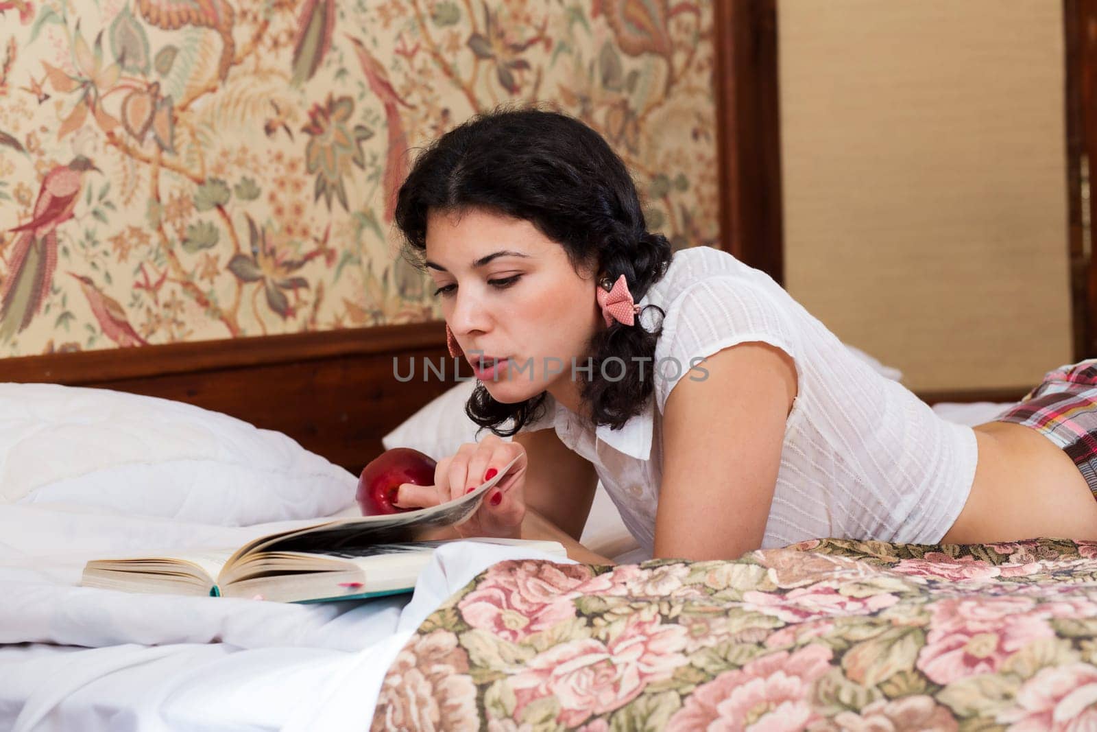 Woman in schoolgirl dress read book with interest