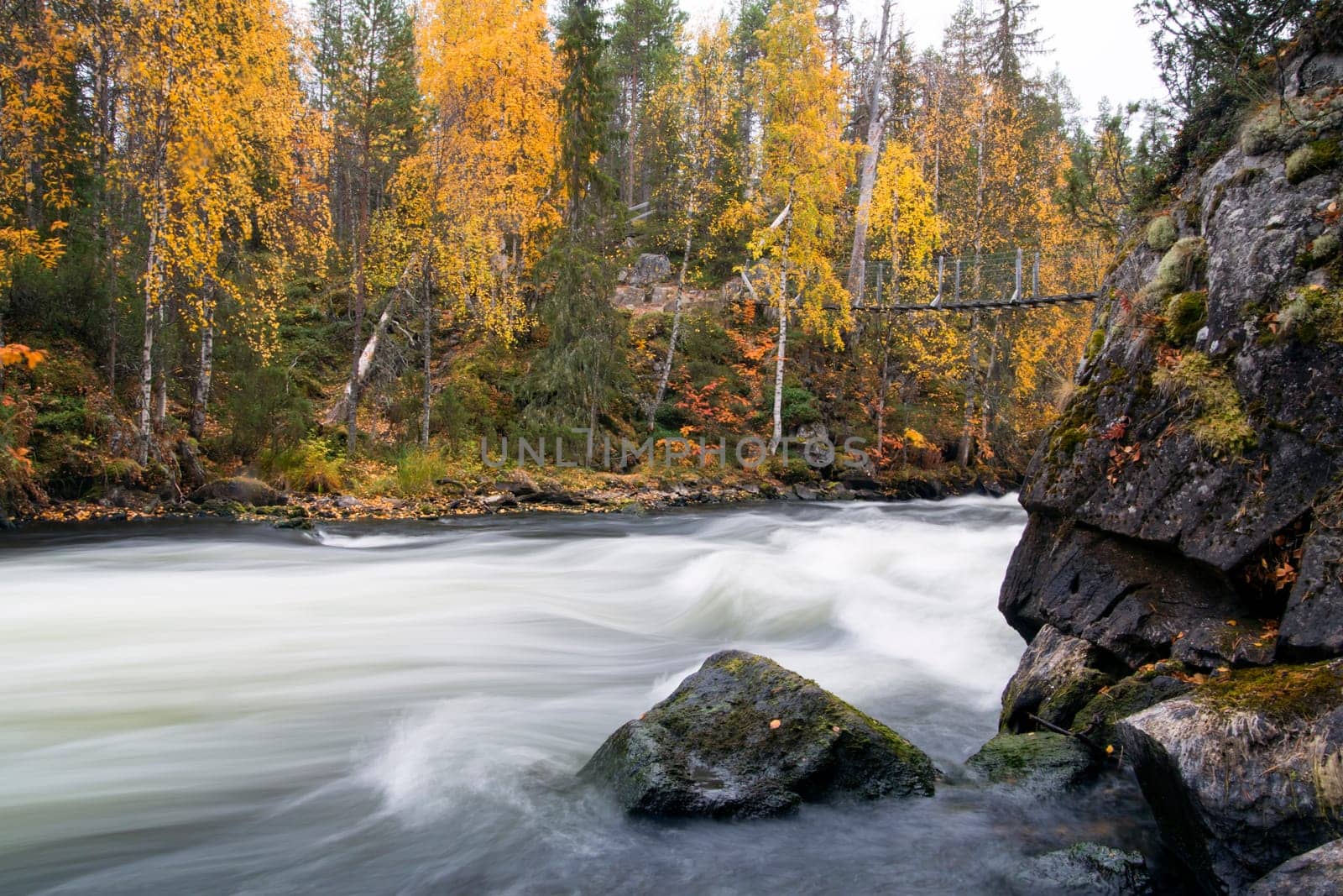 Fast flowing river flow over rocky sturdy coast