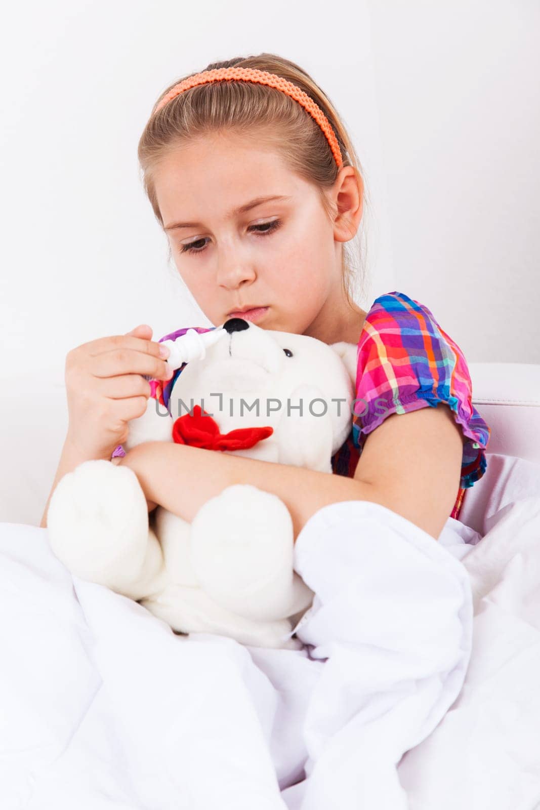 Cute girl doctor with teddy bear