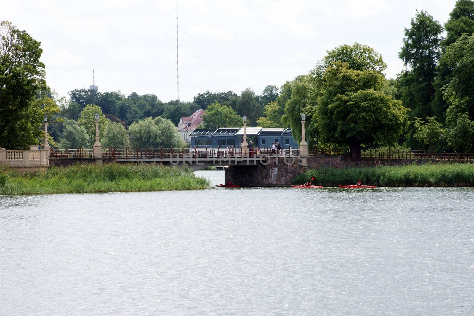 Schwerin,Germany – August 11,2013: Three canoeists pass under a bridge on Lake Schwerin in Schwerin on August 11,2013.