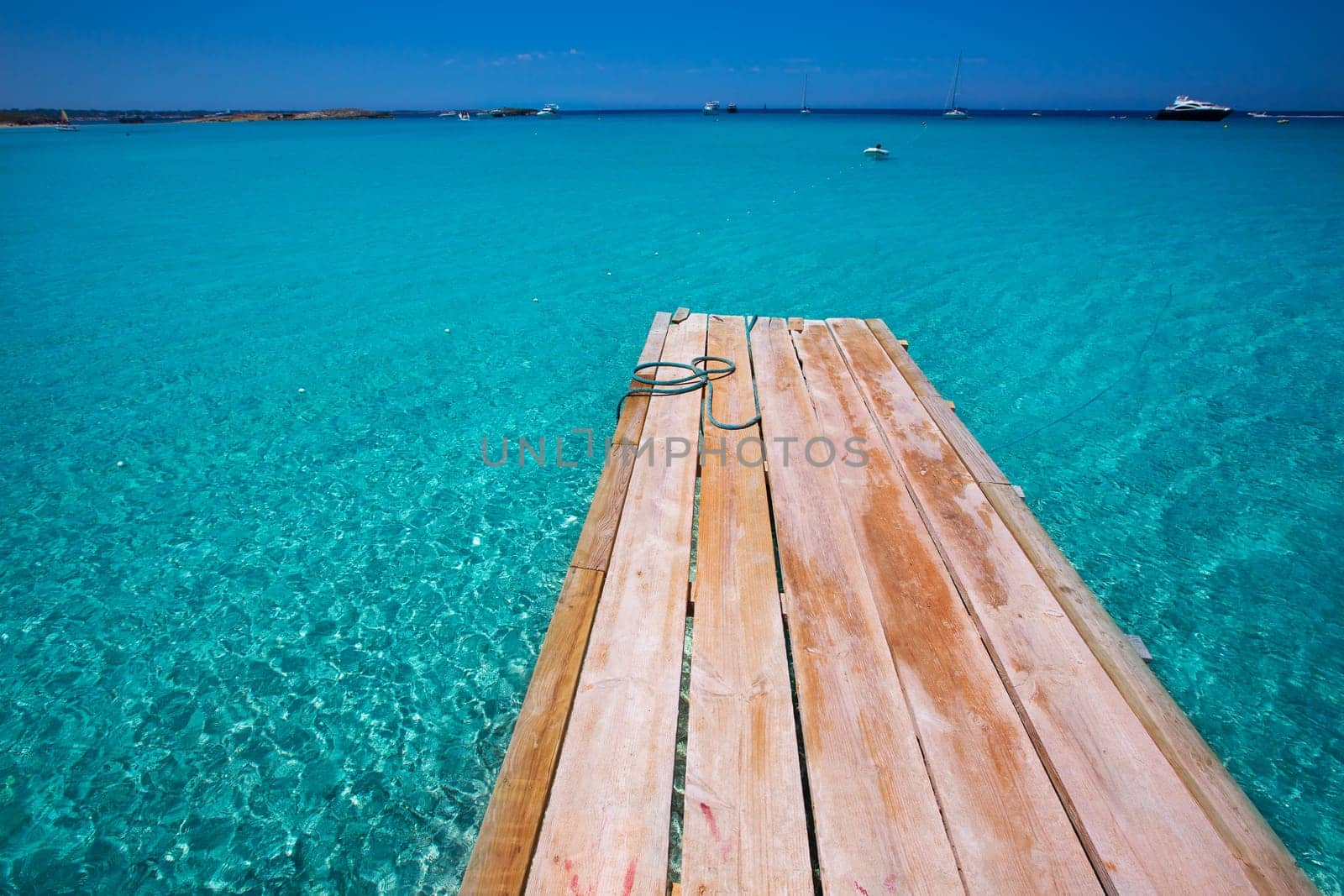 Formentera Ses Illetes beach pier Illetas with Ibiza background at balearic islands