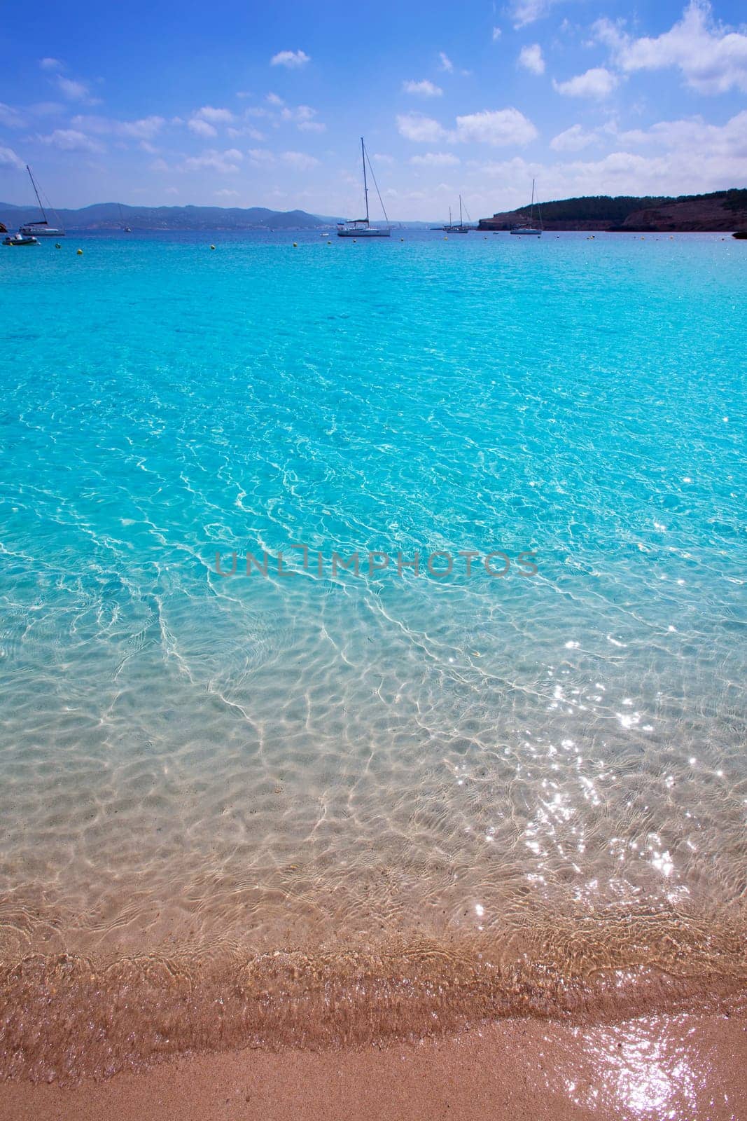 Ibiza Cala Bassa beach with turquoise Mediterranean sea at Balearic Islands