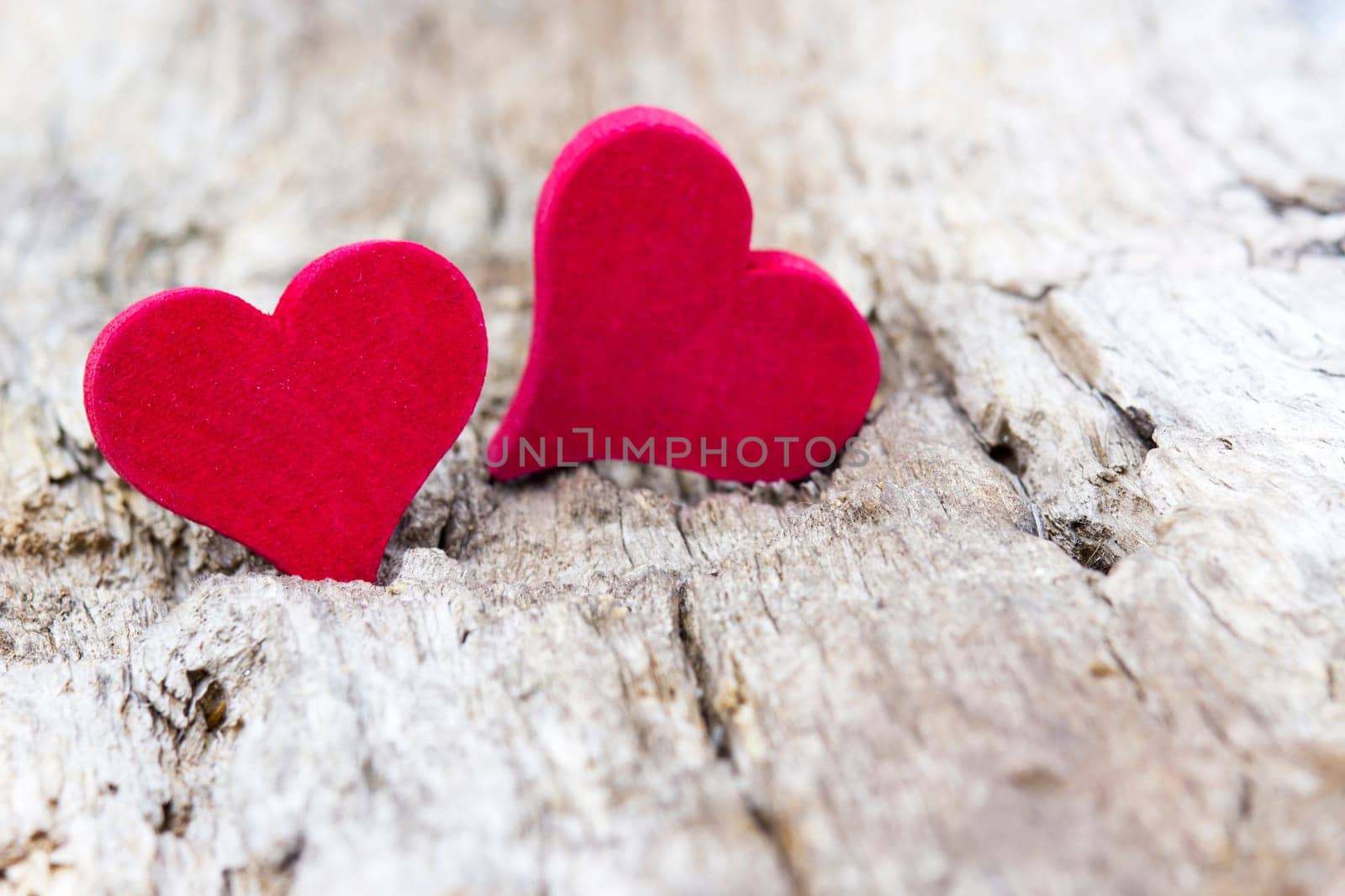 two red hearts on wooden background