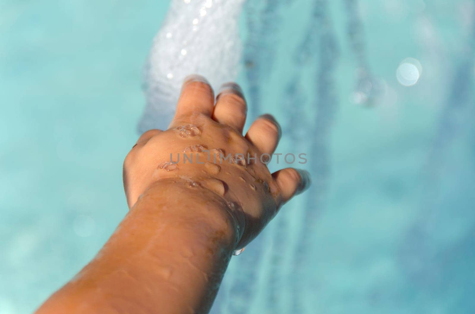 baby hand on a fountain