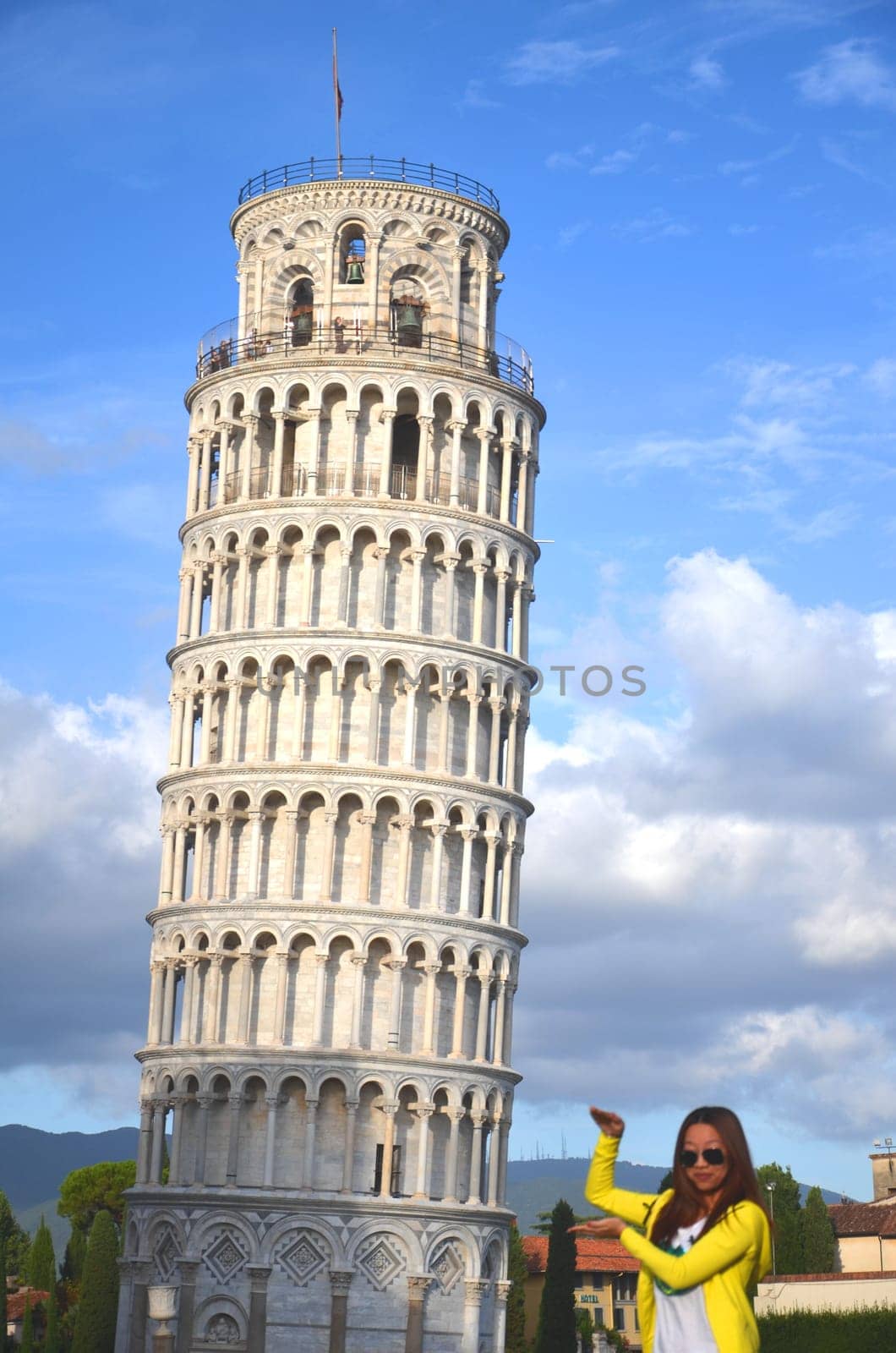 Tourists on Square of Miracles visiting Leaning Tower of Pisa, Italy.