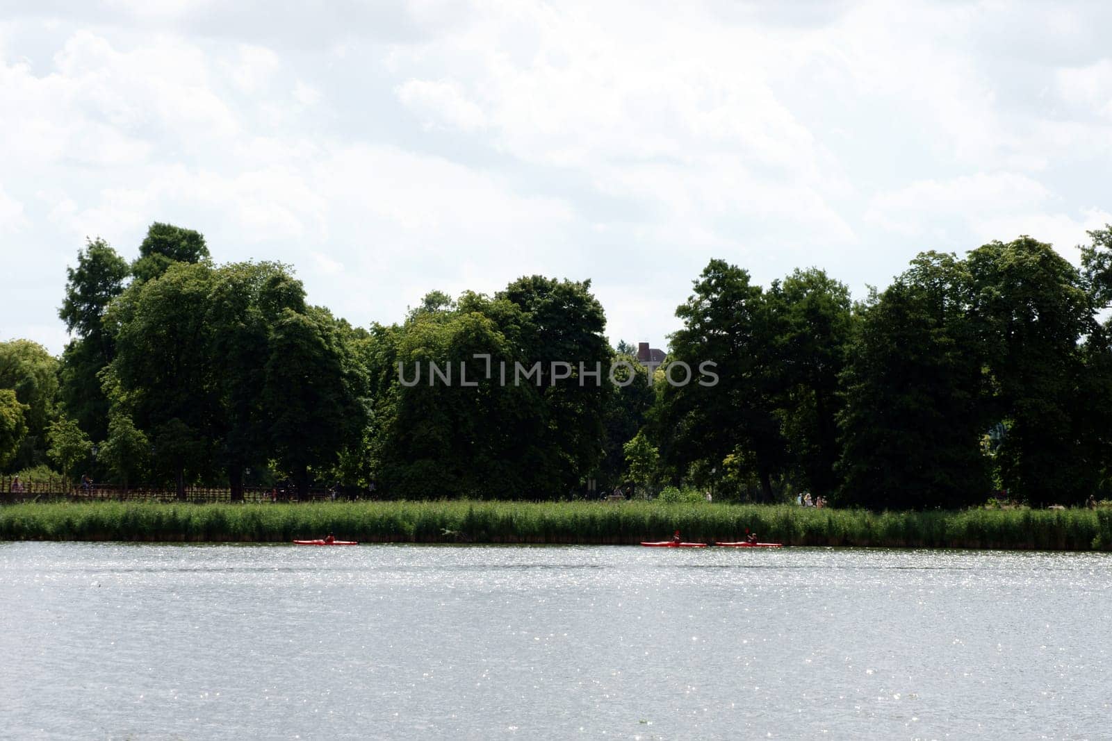 Three canoeists sail along the shores of Lake Schwerin.