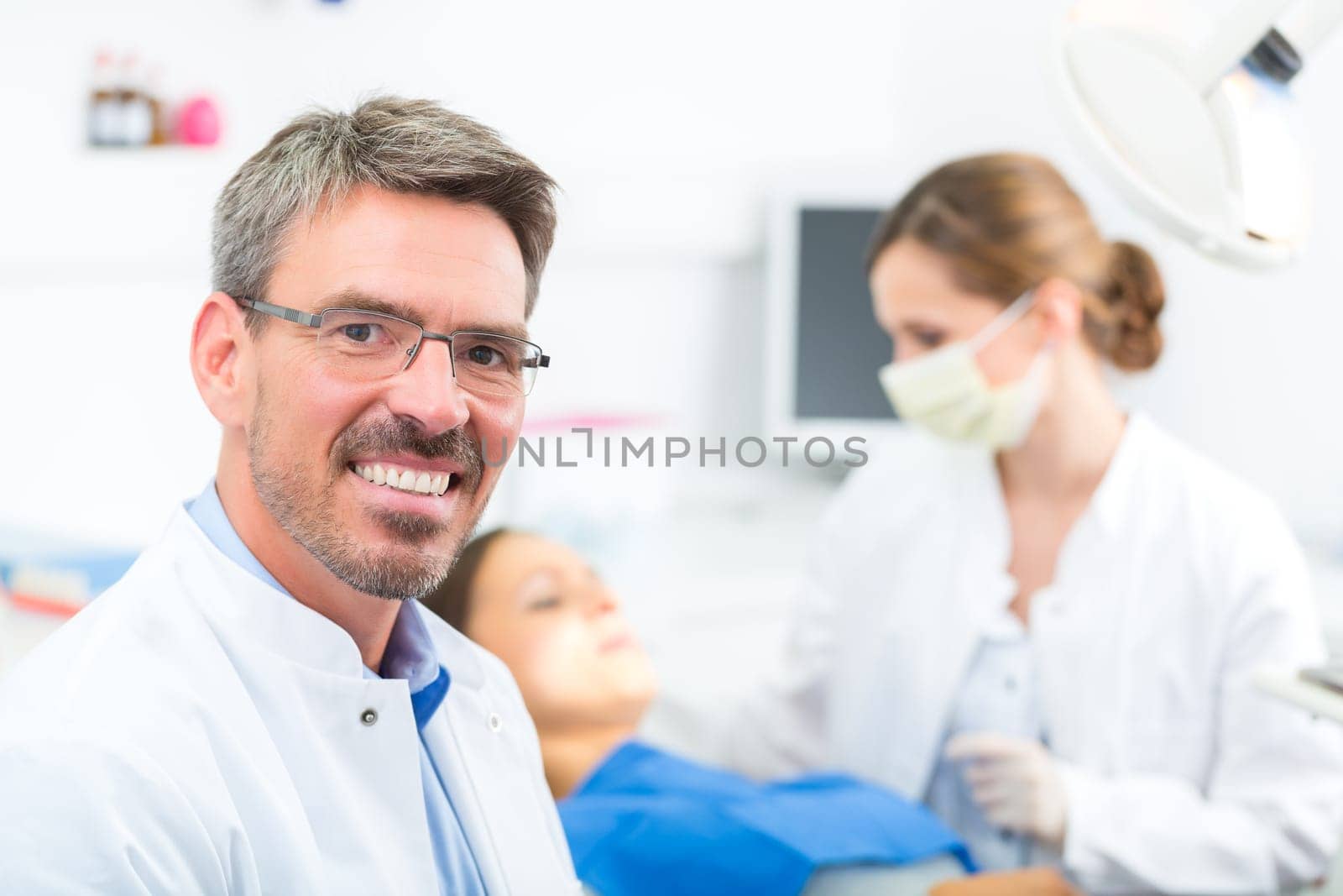 Experienced dentist in his practice