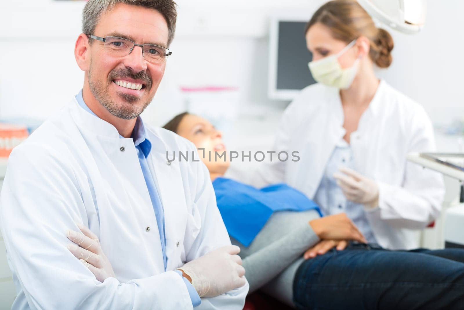 Experienced dentist in his practice