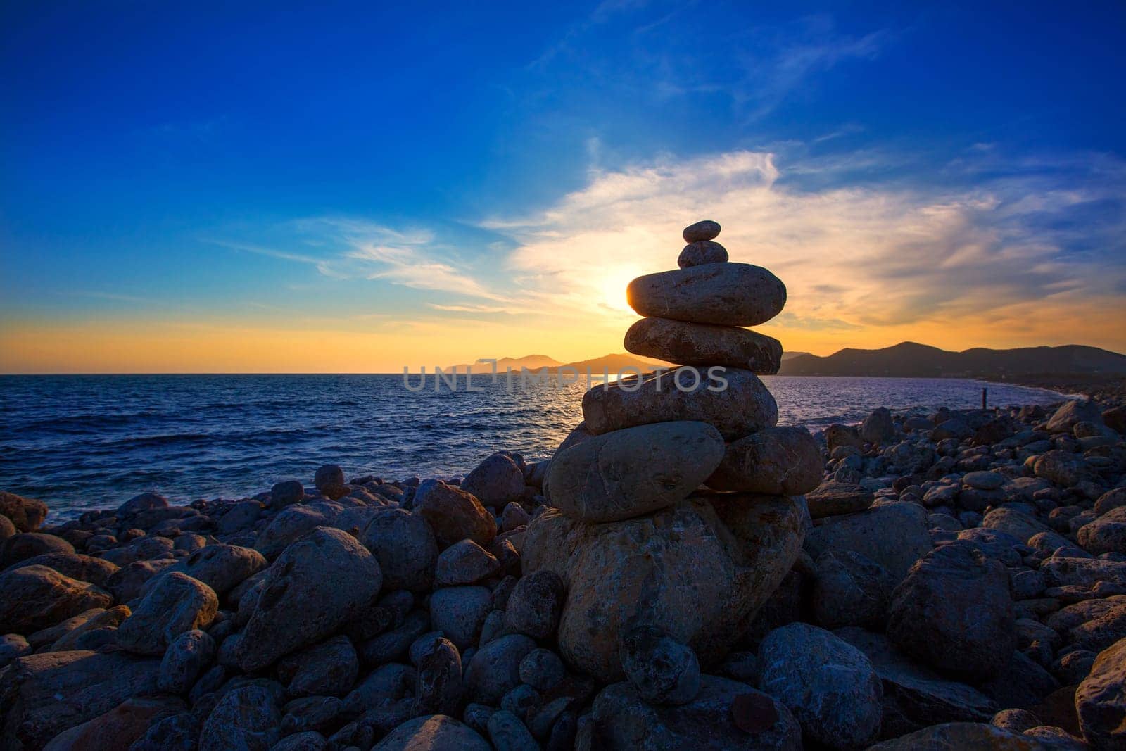 Ibiza Cap des Falco sunset with desire stones at the beach in Sant Josep Balearic Islands