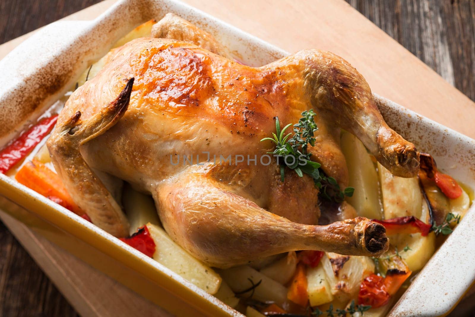 Whole roasted chicken with herbs close up shoot