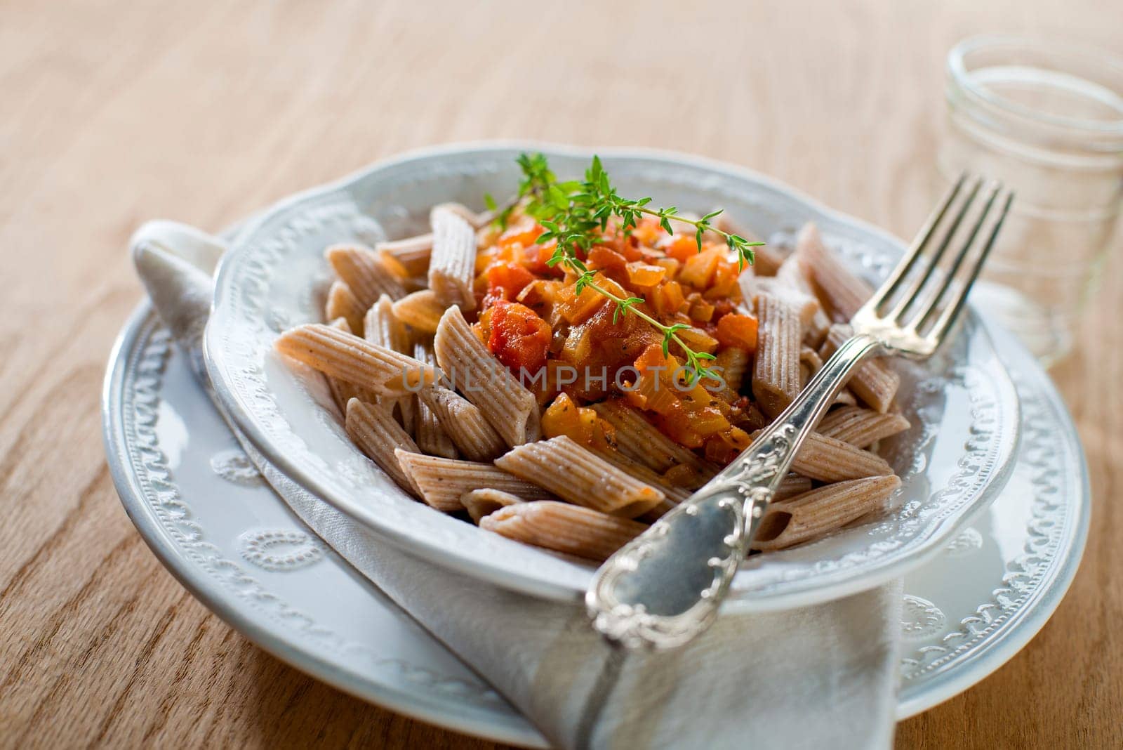 Whole grain pasta with tomato sauce close up shoot