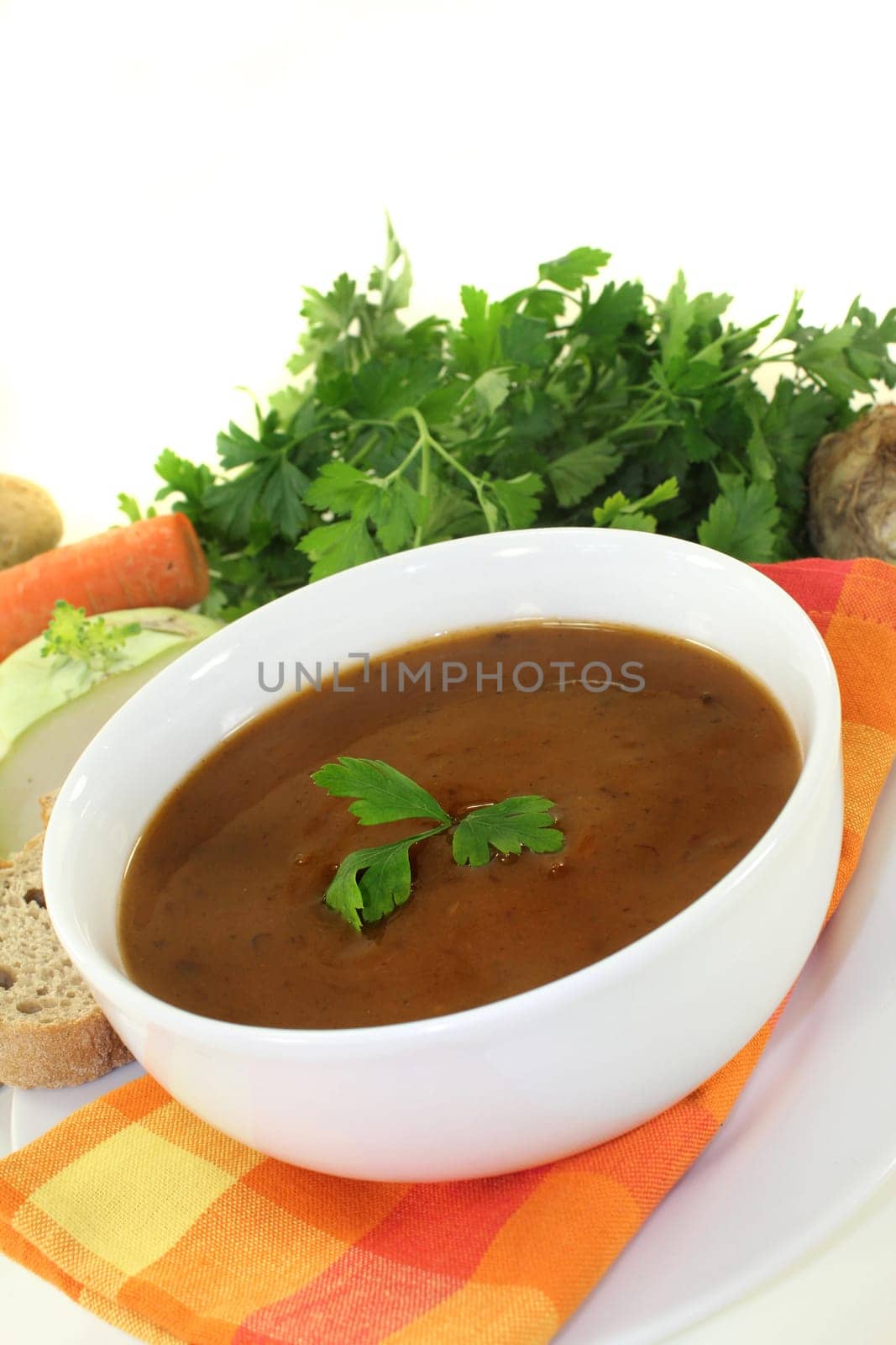 a white bowl with oxtail soup and parsley