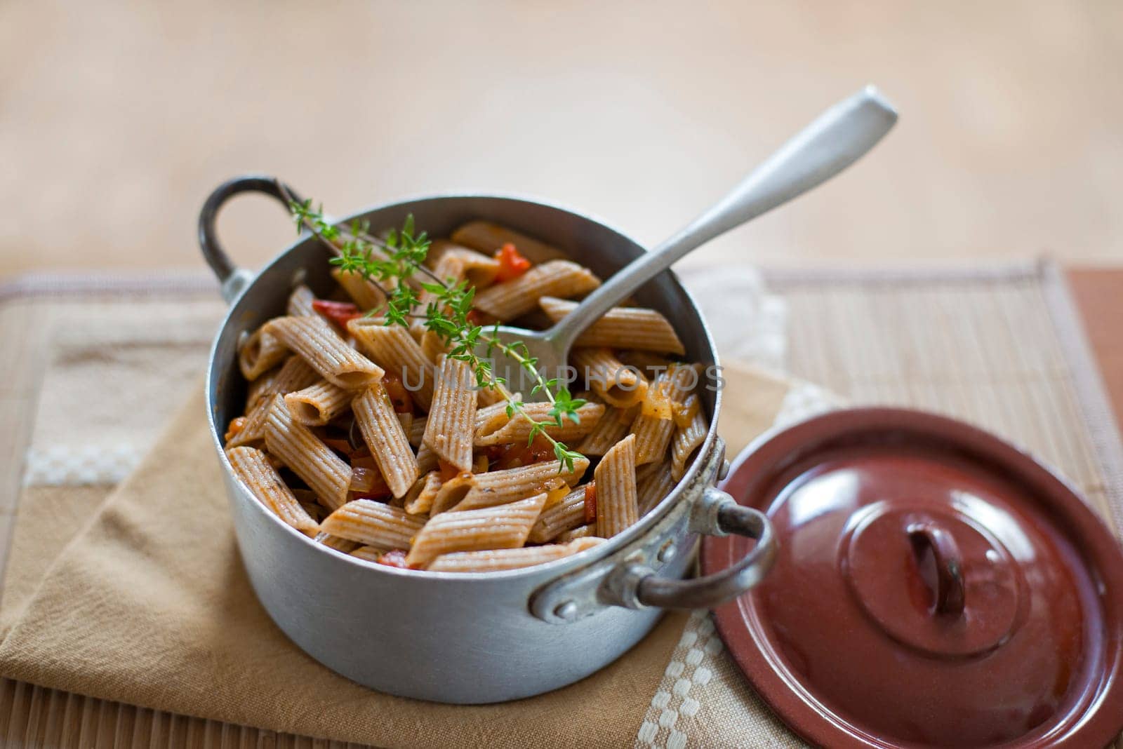 Whole grain pasta with tomato sauce close up shoot